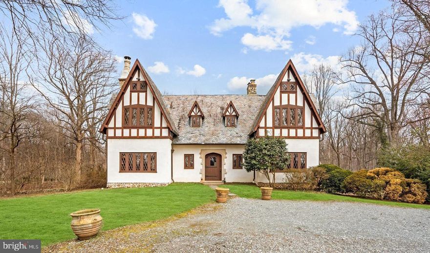 Unique 1929 Tudor home on 3.6+ acres offers a breathtaking 2-story oak Great Hall w/ fieldstone fireplace, sweeping wood staircase, oak paneled main level w/ multiple stone fireplaces, & 1920's craftmanship throughout. Charm and elegance not available in newer homes. Flat open lot high above Georgetown Pike w/ privacy & tennis court. Unique opportunity to expand or make your own. The lot allows for 1 home.  The most recent permits from 2008 indicated a land PERC for 6 bedrooms, however buyer should conduct their own due diligence.   Home is on city water however abandoned well remains.