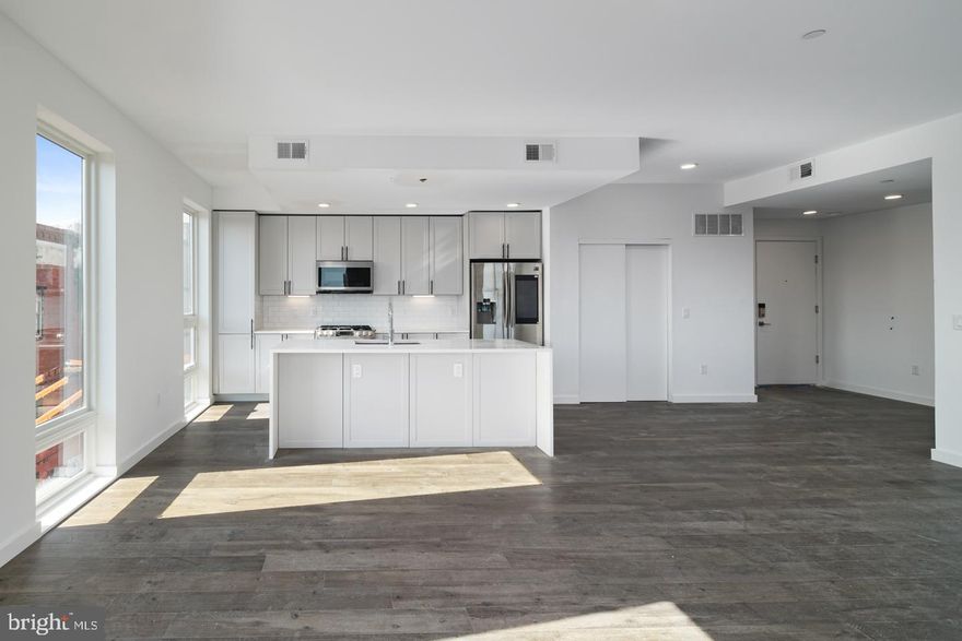 This property qualifies for a 1% INTEREST RATE BUY DOWN for the 1st year at ZERO cost when using the preferred lender! Welcome to Otto on the Park, a sophisticated collection of contemporary condos offering the convenience of parking and more. Enjoy a tax abatement through 2032! Amidst a burgeoning neighborhood, this unit boasts a private balcony and a shared roof deck with breathtaking skyline views. The open floor plan features hardwood floors, soaring ceilings, and abundant natural light throughout. The spacious living area includes large windows, recessed lighting, and ample space for an entertainment setup. A dining area with balcony access compliments the chef-style kitchen equipped with white cabinetry, a generously sized island with breakfast bar, subway tile backsplash, and stainless steel appliances. The unit offers three well-appointed bedrooms with ample closet space. Both graciously sized bathrooms are elegantly designed with beautiful finishes. Additional highlights include in-unit laundry facilities and convenient storage space. Residents can enjoy a communal roof deck featuring a kitchenette, grill, skyline panoramas, dog run, and room for gatherings. Nearby amenities include Revival Brothers Coffee across the street, as well as proximity to Fairmount attractions such as the Schuylkill River Trail, Boathouse Row, and the Philadelphia Zoo. Taxes & square footage are the buyer's responsibility to verify independently. Photos are for marketing purposes only and may not portray actual finishes/be from another unit. Inquire with the listing team for more details. The PAR Standard Agreement of Sale for New Construction must be used for new construction properties, whether completed or not.
