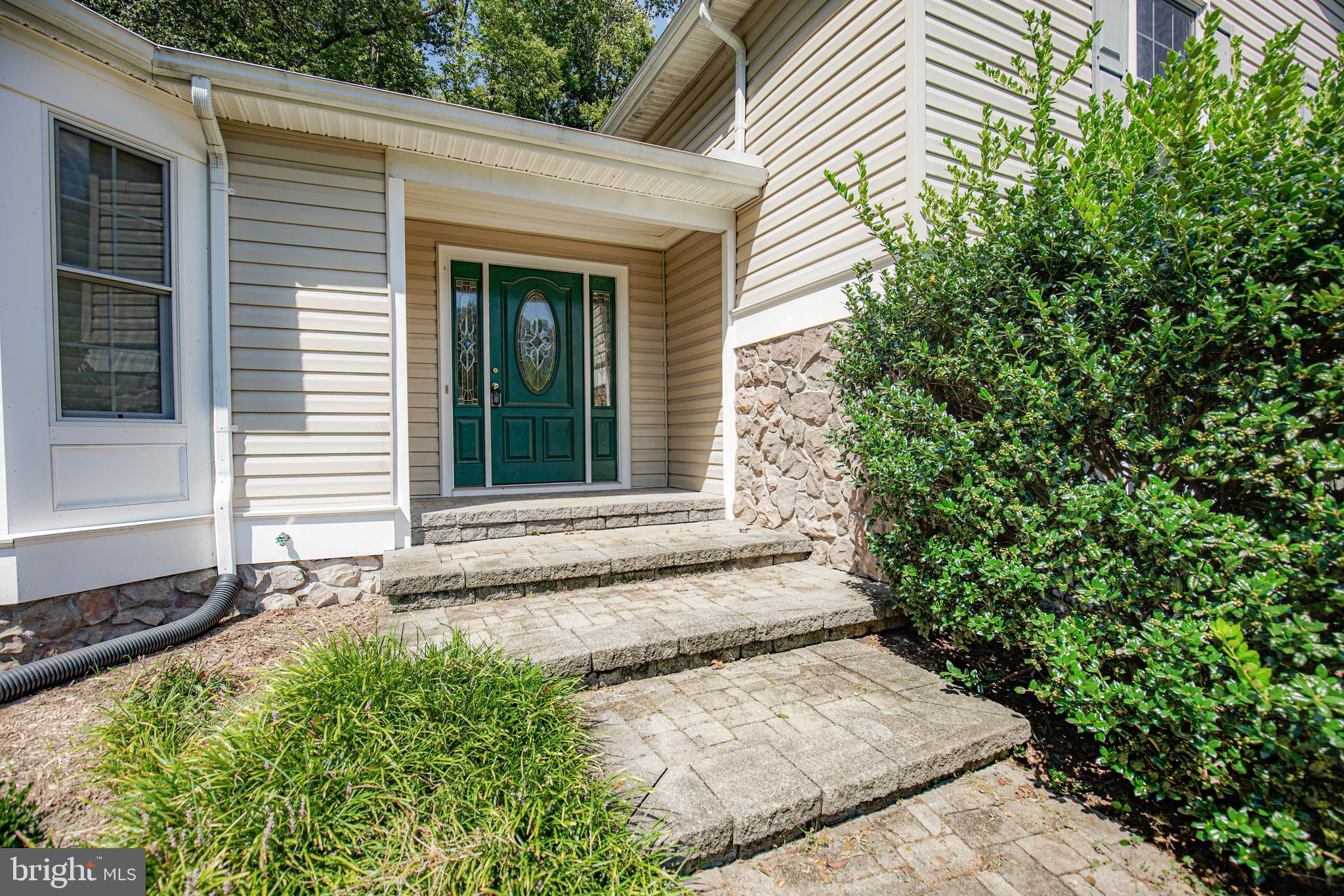 **Price adjustment**
Quiet Acres isn’t just the name of the neighborhood—it’s the lifestyle this stunning, custom-renovated home offers. Gutted and completely rebuilt in 2006 by a custom builder, this 4,588 sq ft split-level residence blends timeless charm with modern amenities in a peaceful wooded setting. Nestled at the end of a quiet lane, the home offers complete privacy surrounded by mature trees and nature.
Thoughtful hardscaping and professional landscaping lead to a welcoming front entry and a paved driveway with a two-car carport and ample guest parking. Inside, luxury vinyl plank floors flow through the main level, connecting the spacious living room, formal dining room, and home office. The light-filled living area offers picturesque views of the yard, while the dining space provides an elegant setting for entertaining.
The gourmet kitchen features Corian countertops, wood cabinetry with custom end caps and under-cabinet lighting, a large island with a granite top and breakfast seating, a walk-in pantry, and stainless appliances. Adjacent to the kitchen, you'll find a half bath, laundry room with utility sink, and direct access to the carport for added convenience.
Upstairs, the private primary suite includes rear deck access leading to a screened porch, two walk-in closets, and a spa-inspired bath with a jetted tub, separate shower, and dual vanities. Two additional generously sized bedrooms share a full hall bath.
Enjoy peaceful mornings or evening relaxation on the screened porch overlooking the serene backyard—frequent visits from deer and songbirds make this a true retreat. The lower level expands your living space with a large family/game room featuring a propane fireplace, a second half bath, and a climate-controlled storage/workshop area. There’s also easy exterior access and mechanicals tucked away for convenience.
Additional highlights include: 3-acre wooded lot with garden views and mature trees; owned solar panels for reduced energy bills; programmable thermostats & full gutter guards; Breezeline broadband internet; ground propane tank (leased through Taylor Gas); large utility shed; and, no HOA.
This exceptional home has an adjacent 4.75-acre wooded lot that you are welcome to purchase too!
Enjoy the best of country living with modern comforts in this one-of-a-kind home—private, peaceful, and move-in ready.