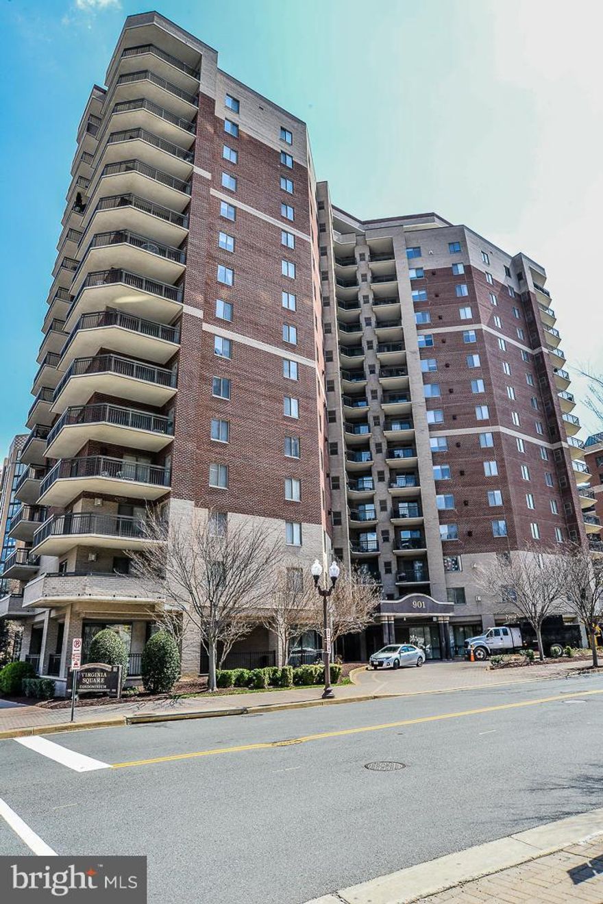 Open House CANCELLED. Location is unbeatable in this perfect 2 BR, 2 BA, across the street from VA Square metro!  This quiet, corner unit offers endless perks: 1105 sq ft of open floor plan, huge, wrap-around balcony, gas fireplace in LR, W/D in unit, closet space galore, 1 garage parking space, & extra storage.  Full-service building offers fitness center, outdoor pool, party room, & concierge.