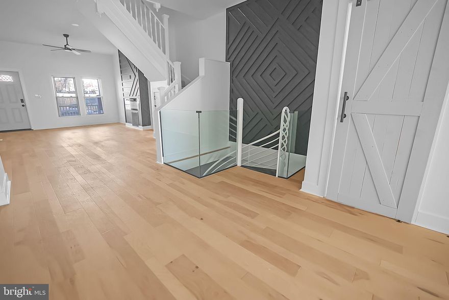 Fully Renovated 4-Story Rowhome in the Heart of Baltimore!

Welcome to a stunning, fully renovated 4-story rowhome that masterfully blends modern amenities with classic charm. Located just minutes from the best of Baltimore, this home has been thoughtfully updated from top to bottom for today’s living.

Upon entering, you’re greeted by a spacious living room featuring a striking accent wall with an electric fireplace, flowing seamlessly into the gourmet kitchen. The kitchen is a chef’s dream, equipped with premium stainless steel appliances, a gas range, quartz countertops, and a generous island, all within an open-concept main level that boasts engineered hardwood floors, high ceilings, and dramatic accent walls—combining contemporary style with traditional character.

The fully finished basement offers extra space for entertaining, featuring recessed lighting, a full bathroom, and direct access to a private parking pad. Upstairs, the home showcases spacious bedrooms, including a master suite with beautiful bay windows, plush carpeting, and spa-inspired bathrooms.

For outdoor entertainment, an expansive deck off the kitchen provides plenty of room for relaxation and socializing. Ample storage space and multi-generational living options further enhance the home's practicality and versatility.

Additional features include two 50-gallon water tanks and two HVAC systems to keep your home comfortable year-round, ensuring optimal efficiency and peace of mind. The seller is also offering a one-year warranty, providing added confidence in your investment.

Located just 2.5 miles from the Inner Harbor and 3 miles from Ravens Stadium, you’re close to all the top attractions that Baltimore has to offer. This fully renovated home is built for entertaining and modern living—don’t miss out!