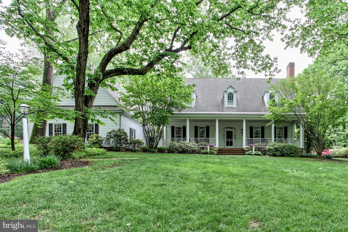 This home in Woodfield Crossing features a striking in-ground pool and brick patio, ideal for enjoying warm weather. Glass doors lead inside to a family room with skylights and exposed brick that opens up to an eat-in kitchen with a double wall oven, island cooktop, and built-in desk. The stately den has a fireplace and numerous built-ins including a wet bar. A convenient first floor master suite has two closets and a whirlpool tub in its bath.
