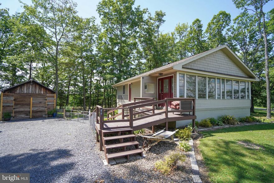 Welcome to 48 Spring Lane! This 2BR/1BA home offers a level lot with panoramic views for eastern sunrises  from the covered porch and western sunsets on the backside of the home. Enjoy an updated kitchen,  renovated full bathroom on the main level, mini splits for AC in the warmer months and plenty of storage space in the unfinished basement area. The lower level has a rough in for a second full bath for future expansion. The oversize garage outside offers great space for storage. Many trees have been cleared on the lot recently providing an open feel with excellent views in all directions. Located just minutes from Oakland and Deep Creek Lake, this is a  great option for a primary residence or second home! Call today for a private showing!