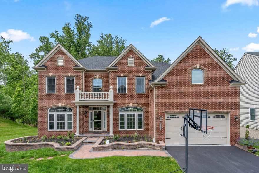 Situated on beautifully landscaped homesite backing to trees is this stunning 5,136sqft brick front residence with perfect curb appeal in coveted Autumn River.  Style and elegance radiate throughout this pristine colonial featuring exquisite profile moldings and trim, designer finishes, a 2-story foyer with a curved staircase, lustrous hardwoods, French doors opening to a private study, classic pillars frame a formal living room adorned by large profile crown molding, and custom heightened windows capped by a sparkling radius window.  A detailed ceiling medallion and profile moldings crown the formal dining room accentuated by fine wainscotting trim and filled with natural light from a heightened double radius window, and a classic pillar outline introducing the 2-story family room adorned by a cathedral ceiling, levels of windows adding loads of natural light, and a cozy fireplace wrapped in a crisp white mantel.  Open and bright chef's kitchen boasts a center island with breakfast bar and pendant lighting, 42' raised panel cabinetry, sleek granite counters with a complementing glass tile backsplash, stainless steel appliances including a 5-burner cooktop, a walk-in pantry, and an open breakfast room with a French door walkout to an elevated low maintenance deck.  Owner's suite presents a double door entry, a crown trimmed tray ceiling, a walk-in closet, and a luxe bath with separate vanities, and oversized glass enclosed shower with seating, and a platform soaking tub.  Adding great spaces is the finished lower level offering wide plank flooring, a rec room, a games area with a wet bar, a theater room with a projector, a full bath, a bedroom, an exercise room, recessed lighting and a walkout to a patio with a retaining sitting wall and tree-lined backyard.