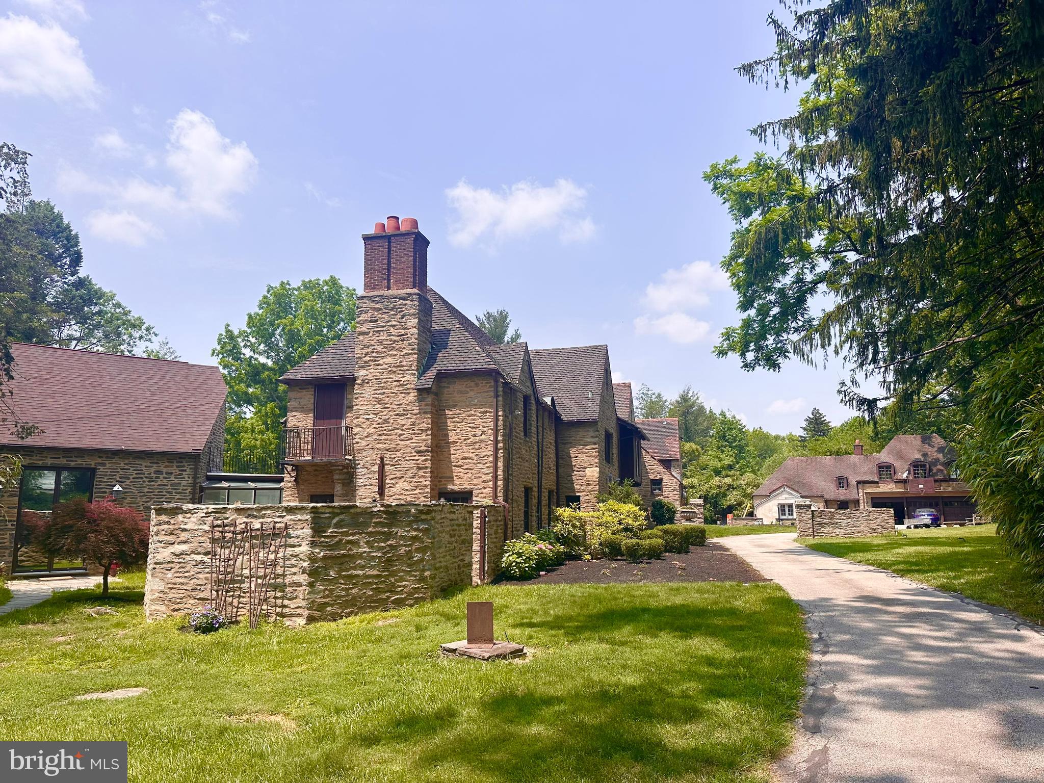 Set on 2.31 acres of private grounds, this 8,300+ sq ft stone estate offers a unique opportunity to own a
compound-like property Located in one of the Main Line’s most prestigious neighborhoods, this extra
ordinary home features three self-contained living spaces, providing unparalleled flexibility. The main residence exudes warmth and elegance, with 8 bedrooms and 4 full baths, making it ideal for a growing household. Classic hardwood floors, multiple fireplaces, and exquisite custom woodwork create an
inviting atmosphere throughout the home. The chef’s kitchen, with quartz countertops and a spacious prep area, serves as the heart of the home—perfect for both meals and entertaining. The formal dining room, adorned with rich wood paneling, provides an elegant setting for larger gatherings, while the cozy living room with its wood-burning fireplace is perfect for relaxation. The wood-paneled office offers a
quiet retreat for work or study, and the renovated bathrooms, including two with luxurious steam showers, provide both comfort and convenience. A true highlight of this estate is the expansive gallery space—a versatile space with vaulted ceilings, exposed beams, and a striking stone fireplace. This self-contained area includes its own kitchen, modern bath, laundry, and private entrance, offering limitless possibilities. Whether used as a home theater, playroom, art studio, event venue, or even a dedicated guest suite, this exceptional space can easily be adapted to suit your needs. Above the detached garage, the carriage house apartment provides another private living space with its own kitchen, living room, bedroom, and bathroom—perfect for extended household, guests, or as a rental unit, The estate’s 2.31 acres create the perfect setting for outdoor enjoyment. Relax by the heated saltwater pool, host summer gatherings on the stone terrace, or unwind in the glass-enclosed sunroom overlooking the serene backyard. With dual private entrances from Remington and Morris Roads, the property offers complete privacy, while still providing easy access to surrounding amenities. Ample parking ensures your guests are always accommodated, making this estate ideal for reunions, holidays, or any large gathering. This estate is an extraordinary place to call home.