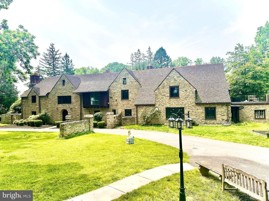 Set on 2.31 acres of private grounds, this 8,300+ sq ft stone estate offers a unique opportunity to own a 
compound-like property  Located in one of the Main Line’s most prestigious neighborhoods, this extra 
ordinary home features three self-contained living spaces, providing unparalleled flexibility. The main residence exudes warmth and elegance, with 8 bedrooms and 4 full baths, making it ideal for a growing household. Classic hardwood floors, multiple fireplaces, and exquisite custom woodwork create an 
inviting atmosphere throughout the home. The chef’s kitchen, with quartz countertops and a spacious prep area, serves as the heart of the home—perfect for both meals and entertaining. The formal dining room, adorned with rich wood paneling, provides an elegant setting for larger gatherings, while the cozy living room with its wood-burning fireplace is perfect for relaxation. The wood-paneled office offers a 
quiet retreat for work or study, and the renovated bathrooms, including two with luxurious steam showers, provide both comfort and convenience. A true highlight of this estate is the expansive gallery space—a versatile space with vaulted ceilings, exposed beams, and a striking stone fireplace. This self-contained area includes its own kitchen, modern bath, laundry, and private entrance, offering limitless possibilities. Whether used as a home theater, playroom, art studio, event venue, or even a dedicated guest suite, this exceptional space can easily be adapted to suit your needs. Above the detached garage, the carriage house apartment provides another private living space with its own kitchen, living room, bedroom, and bathroom—perfect for extended household, guests, or as a rental unit, The estate’s 2.31 acres create the perfect setting for outdoor enjoyment. Relax by the heated saltwater pool, host summer gatherings on the stone terrace, or unwind in the glass-enclosed sunroom overlooking the serene backyard. With dual private entrances from Remington and Morris Roads, the property offers complete privacy, while still providing easy access to surrounding amenities. Ample parking ensures your guests are always accommodated, making this estate ideal for reunions, holidays, or any large gathering. This estate is an extraordinary place to call home.