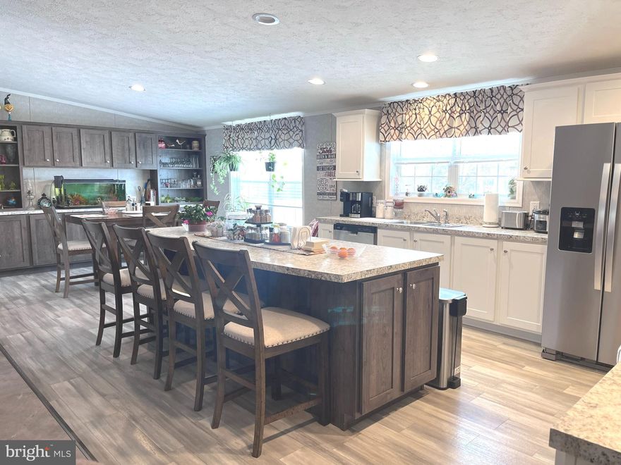 This stunning 2023 double-wide offers beauty, space, and all the extras! Enjoy an open-concept layout that seamlessly connects the kitchen, dining area, and living room—perfect for everyday living and entertaining. Featuring 3 spacious bedrooms, each with its own walk-in closet, 2 full bathrooms, a dedicated laundry room, brand new decks, and storage galore. This home is truly move-in ready!