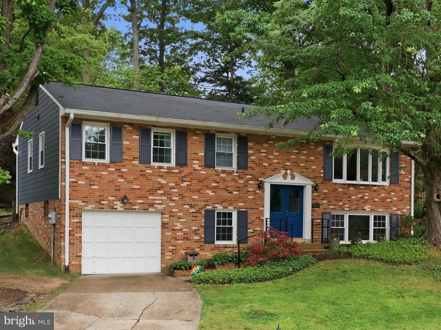 Tucked away on a quiet, tree-filled cul-de-sac in the heart of Vienna, this beautifully updated brick-front home offers the perfect blend of nature, style, and convenience in the highly sought-after Wolftrap/Kilmer/Madison school pyramid. Backing to a breathtaking backyard oasis that feels more like a private nature preserve, this turn-key 4-bedroom, 3-bath home is filled with thoughtful upgrades, abundant natural light, and timeless charm.

With 2,285 square feet of finished living space, a 1-car garage, hard-surface flooring throughout (no carpet!), and extensive updates inside and out, this home is truly move-in ready. From the moment you arrive, the upgraded double front doors, custom railings, and impressive foyer set the tone for the stylish finishes found throughout.

The spacious upper level features gleaming hardwood floors, recessed lighting, and sun-filled living spaces designed for both everyday living and entertaining. The living room showcases a stunning bay window overlooking the peaceful cul-de-sac and mature trees beyond. The oversized Dining Room — complete with another large bay window — flows seamlessly into the Sitting Room, where sliding glass doors open to the gorgeous brick patio and fully fenced backyard retreat.

The renovated Kitchen is absolutely stunning, featuring white cabinetry, stainless steel appliances, gas cooking, double ovens, quartz countertops, a beautifully tiled backsplash, and a massive butcher block island. Enjoy your morning coffee beside the huge picture window with serene backyard views. Down the hall is the corner Primary Suite, which offers multiple windows and a beautifully renovated bath with dual sinks and a gorgeous tiled walk-in shower. Two additional bedrooms and an updated hall bath complete the upper level.

Downstairs, the fully renovated lower level features new LVP flooring, an incredible Rec Room with a white brick wood-burning fireplace and oversized mantle, a renovated full bath, and a spacious fourth bedroom with full-size window and large closet. A large Laundry/Storage/Utility Room with utility sink and additional storage space adds functionality and convenience.

Outside, the tiered and fully fenced Backyard offers endless possibilities for entertaining, gardening, relaxing, birdwatching, or play. Surrounded by mature landscaping and frequent visits from birds, deer, owls, frogs, chipmunks, and more, this incredible property feels like a private escape while still being close to everything.

Major recent updates include: new hardwood flooring (2020), new attic insulation (2020), new recessed lighting and light fixtures - ceiling fans and lights (2020), new dining room windows (2020), renovated Kitchen (2020), new exterior doors – front door, sliding glass door to backyard (2020), new roof, gutters, and gutter guards (2020), new Hardie siding (2021), renovated lower level bath (2021), new kitchen windows (2021), new backyard hardscape - retaining walls and brick patio (2021), new interior doors (2022), new backyard drainage system (2022), new LVP flooring on lower level (2022), new exterior and interior custom stair railings (2024).

Located just steps from Northside Park with direct access to the W&OD Trail, scenic walking trails, winding creek, and 26 acres of parkland. Walking distance to Wolftrap Elementary, Church Street and Maple Avenue shops/restaurants, and just minutes to Wolf Trap Performing Arts Center, Tysons, Reston, Dulles Airport, and DC. Enjoy all that the Town of Vienna has to offer — without the added in-town tax!