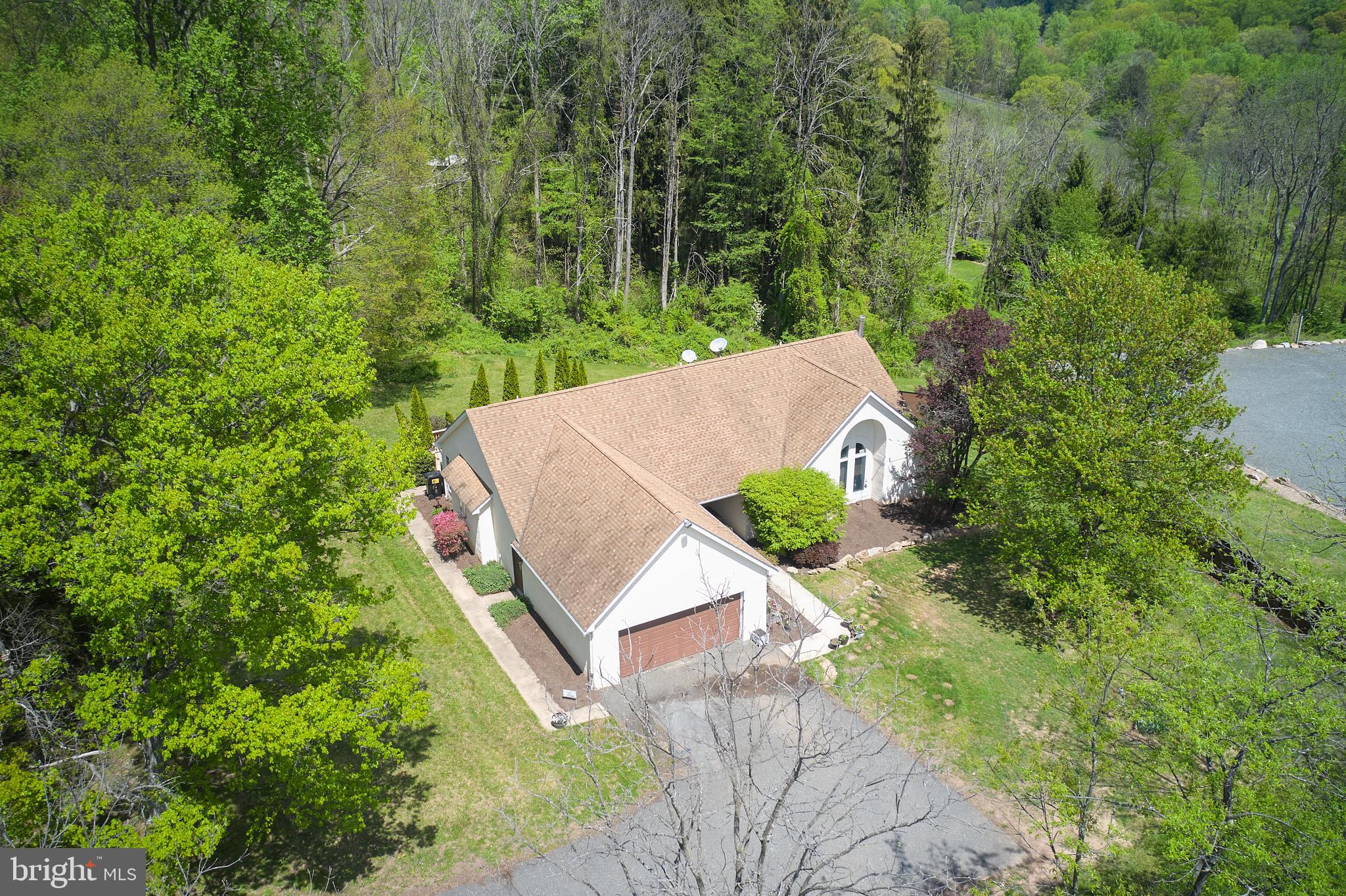 This spacious three-bedroom home offers a perfect blend of comfort and functionality just a short distance from Rt 100. The open and updated kitchen with eat-in area seamlessly flows into the family room and dining area, creating an inviting space for gatherings and plenty of room for relaxing. The primary suite features a private en-suite bathroom and walk in closets, while the additional two bedrooms share a well-appointed hall bath. The large lower level includes a recreation area, dedicated office space, plenty of storage room and a convenient walk-out, providing additional room for relaxation and productivity. This home features a private deck off the kitchen that overlooks the large yard ideal for outdoor entertaining or quiet time as well as a two car, attached garage. This home is designed for everyday living and convenience.