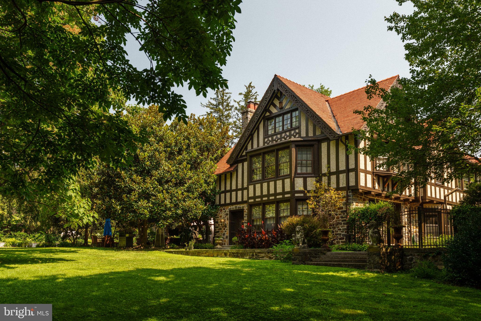 Littlefield Farm, a warm, expansive Tudor revival estate nestled on almost 3 acres on the south side of Bryn Mawr, represents the epitome of family-oriented living for the discerning buyer. This grand residence was built in 1912 by the renowned firm of Duhring, Okie & Ziegler for Edwin L. Blabon. Lovingly stewarded for more than 20 years, it’s timeless elegance and historical charm are ready to envelop a new family.
The house spans an impressive 12,000 square feet, featuring eight oversized bedrooms, nine elegant bathrooms and eight working fireplaces. A custom chefs eat-in kitchen, complete with an expansive pantry and distinguished butler's pantry, opens onto a flat patio replete with mature specimen trees and lush pool area. This home is especially oriented for grand entertaining, featuring a second kitchen on the first floor for catering and intimate family gatherings. The grand entry foyer, lined with hand-carved wood panels, blends seamlessly into the family room, library and formal dining room. Every space achieves a striking balance of warmth and scale.
The basement boasts room for ample storage, a gym and a state-of-the-art 9,000 bottle wine cellar. All systems have been updated under current ownership.
Beyond the main residence, the estate boasts two additional structures: a finished pool house with a welcoming living area, full bath, and gourmet kitchen, and a detached two-car garage with an open-floorplan apartment, full bath and kitchenette. Having been divided into two separate residences during the 1980’s, Littlefield Farm is the product of the current owner’s passion and persistence in restoring the home to its original glory. Perched at the top of a cul-de-sac, it is a triumph of graceful yet informal living, while showcasing the hallmark architectural details of a traditional Tudor home. Littlefield Farm is a dream backdrop for family life and is strategically located in the Radnor School District and within proximity to Baldwin, Shipley, Haverford, Episcopal and Sacred Heart.