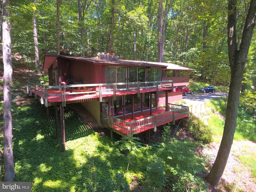 PLEASANT VALLEY FARMS - Get refreshed! Relish the enduring lifestyle choice in this coveted Monkton locale on 30+ acres. Stunning Acorn Co. Deck House elevates your daily existence with mid-century modern and rustic Monkton. Well curated use of elemental glass, wood & beams and open spaces to connect with natures beauty. Immersed in natural light, walls of glass open to soothing outdoor living, expansive decks, glistening pond views and meadows. Modern, gourmet kitchen overlooking natural rock formations will provide true inspiration. Glistening oak and cherry hardwood floors, contemporary open tread stairway, spacious great room warmed by brick fireplace, large master suite with renovated master bath overlooking nature. Stroll the wooded path to your private spring fed pond and sun on the rustic dock. Animals welcome too as the three stall barn with electric and water, sand riding ring, five pastures provide the optimal settling for horse lovers. Additional board & baton barn and corn crib with standing metal roof (15? clearance) offer room for additional stalls, equipment and toys. All in the sought after Hereford Zone! Subject to MET Easement.