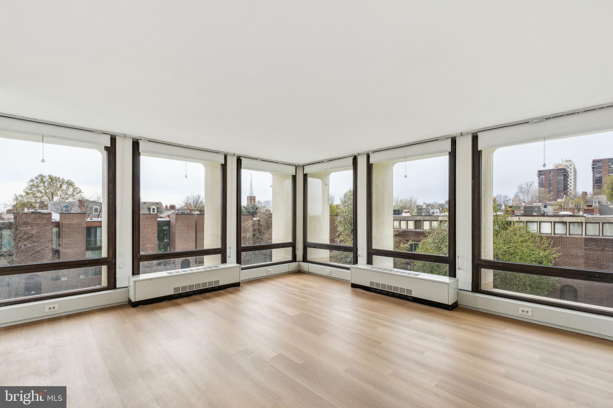 Corner one bedroom with beautiful treetop vistas and incredible natural light throughout at Society Hill Towers! Enter through a foyer with large coat closet into the spacious living/dining room with two walls of floor-to-ceiling windows showcasing southwest treetop views. The fully equipped galley kitchen features ample white cabinetry, solid surface countertops, white appliances, and a tile floor. The generously sized bedroom enjoys more floor-to-ceiling windows, a large wall closet, and use of an adjacent hall bathroom with white vanity and tub shower boasting stylish tilework. There are brand new wood-like floors and excellent closet space throughout. Residents of Society Hill Towers enjoy a 24-hour doorman and all utilities plus basic cable. Access to the building's outdoor seasonal pool, fitness room, storage lockers, and parking in the building's underground garage are available for an additional fee. Also, there is an on-site Philly Car Share, a coin operated laundry room in the basement, and a shopping plaza on site with a market, dry cleaner, beauty salon, and one of Philly's most acclaimed restaurants, Zahav.