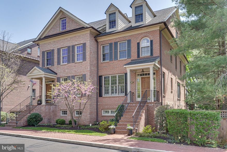 Discover this beautifully appointed brick twin nestled in the bucolic Phillips Court neighborhood of Newtown Borough. This exceptional residence offers a seamless blend of comfort, style, and convenience, highlighted by a light-filled open floor plan and a private elevator servicing the garage and main living levels.
Upon entry, refined architectural millwork, designer lighting, and rich hardwood floors set an elegant tone. The gracious foyer opens to a stunning dining room, thoughtfully designed for both intimate gatherings and formal entertaining.
At the heart of the home, the gourmet kitchen is as functional as it is striking—featuring a Sub-Zero refrigerator, six-burner Wolf gas range, wine refrigerator, crisp white cabinetry with accent lighting, and sophisticated marble countertops. A generous center island invites guests to gather, while the adjoining dining area flows seamlessly into the great room.
The great room offers a warm and inviting atmosphere, highlighted by a gas fireplace flanked by custom built-in display cases and complemented by plantation shutters found throughout the home. Expansive glass doors lead to a private slate terrace overlooking mature trees—an ideal setting for quiet evenings or alfresco dining with friends.
The second level is anchored by a magnificent primary suite, offering a serene bath retreat featuring a whirlpool tub, an expansive double shower with natural tile, and a double vanity. An exceptional walk-in closet, along with two additional closets, provides abundant storage. A spacious second bedroom with its own private bath, and a convenient laundry room with utility sink complete this floor.
A third level offers remarkable flexibility, ideal as a private guest suite with full bath and separate sitting area, or as a media and gathering space as currently enjoyed. An additional room on this level lends itself beautifully to a quiet home office, fitness studio, or cozy reading retreat.
The finished lower level creates an inviting extension of the home, featuring a wet bar, wine refrigerator, and powder room—perfect for entertaining or relaxing while enjoying sports and movies. A two-car garage, equipped with an electric vehicle charger, offers everyday convenience and is easily accessed by the elevator.
Enjoy the convenience of in-town living with a short stroll to Newtown Borough’s renowned restaurants, coffee shops, and boutiques while residing in a private enclave of refined homes.