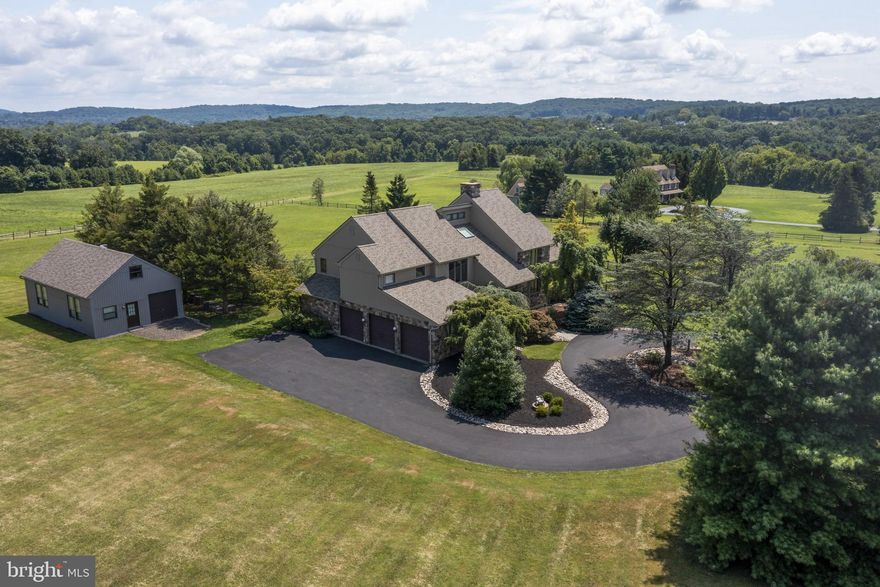 Magnificent 6.5-acre pastoral estate nestled deep in the rolling hills and woodlands of Bucks County. This custom-built contemporary home offers a rare opportunity for those who seek tranquility with nearby modern conveniences. This home offers breathtaking views of nature’s beauty along with professionally manicured grounds and is backed by preserved farmland so you can relax by the pool and enjoy the grounds in total privacy.  Entering the foyer, you are met with an elegant, curved stairway and tiled floor.  To the left is the formal dining room, and to the right is the stately, sitting room, complete with fireplace and floor to ceiling stone wall. The sitting room opens to the two level, vaulted, and beamed great room featuring hardwood flooring and is bathed in light from three sides.  From here and the rest of the home you will enjoy the stunning 360-degree views of the expansive countryside through the numerous windows. From the great room step on to the deck that extends along the rear of the home and overlooks the pool, backyard and farmland.   The kitchen is more than a kitchen, it is a grand space with a sitting area in addition to the table, granite island and counter tops. Plenty of cabinets and a large custom pantry. The kitchen table sits surrounded by floor to ceiling windows providing a panoramic view. Access the deck from the kitchen and enjoy your morning coffee. On the main floor is a second master bedroom with an adjoining full bath.  Completing the main floor is the laundry room, with a very convenient laundry chute from the second floor.  Upstairs, the spacious master bedroom has two oversized walk-in closets and a private balcony, providing a vista of the pool and countryside all the way to the Solebury mountains.  The immense master bathroom has a double sink vanity, jacuzzi tub and a walk-in shower. The other two bedrooms are amply sized with plenty of closet space. One of these bedrooms has a private balcony as well. Also on this floor is a full hall bath. The finished basement is primed for entertaining. There is a full wet bar with a dishwasher. There’s room enough for a pool table, card tables, sofa, and entertainment center. There is also a full bathroom with a stall shower. The rest of this level is storage, mechanicals and a workshop. Outside, relax in your custom designed pool, which is surrounded by a concrete and brick deck. The gunite was resurfaced in 2017. In addition to the main house is a two story carriage house with electric. Water pipes have been extended but have not been connected. It is currently used for storage and a workshop. This could easily be transformed into a guest house. The possibilities are endless. This secluded estate is within minutes of Newtown, Doylestown, New Hope, and Flemington with easy access to major highways. This is the idyllic lifestyle most can only dream of, so come for a tour and experience a taste of your new beginning! Links above to our Virtual Tour and Photo SlideShow and Aerial Tour. 

Roof and siding were replaced in 2020. New AC in 2020. Hardwood floors throughout the home.