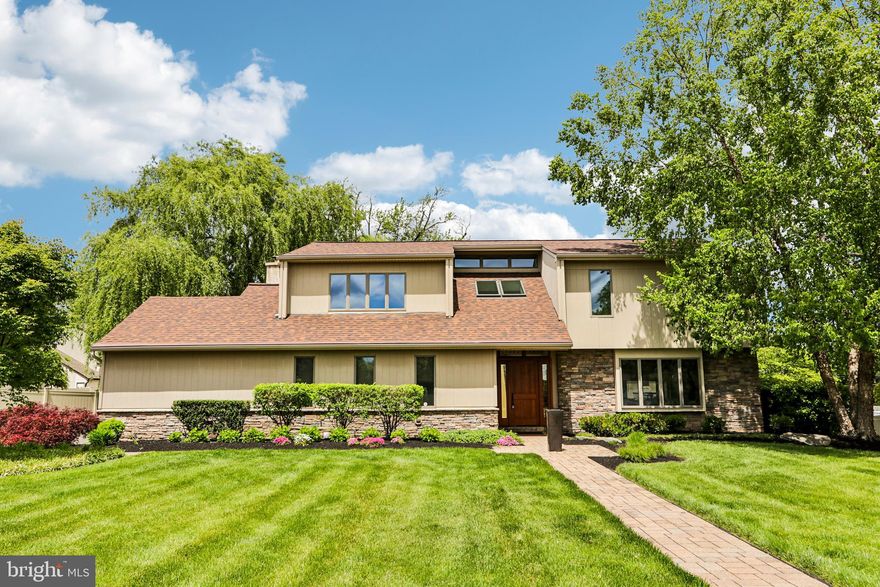 Introducing 93 Kent Road, a refined Fred Betz & Sons custom contemporary residence in Huntingdon Valley, showcasing exceptional craftsmanship, thoughtful design, and an extensive collection of high-end upgrades. Set on a beautifully maintained half-acre lot in a quiet cul-de-sac, this 4-bedroom, 2.5-bath home offers a seamless blend of elegance and modern functionality. A dramatic two-story entry with skylights sets the tone, opening to sophisticated living spaces defined by radiant-heated tile flooring, rich hardwood floors, custom millwork, and carefully curated lighting.

The gourmet chef’s kitchen is a true centerpiece, appointed with custom Pennsville solid maple shaker cabinetry, granite countertops, a tumbled marble backsplash, and a spacious island. A full suite of premium appliances includes SubZero refrigeration, a Viking 6-burner gas range with professional ventilation, and Dacor built-ins (including a wall oven, warming drawer, and microwave) and new dishwasher. A thoughtfully designed pantry features custom shelving and spice racks, while the adjoining dining area provides direct access to the fully fenced backyard.

The adjacent den offers a warm and inviting atmosphere with 9-foot ceilings, a striking stone fireplace with hearth, mantle, and gas insert, as well as custom cherry built-in bookcases and refined finishes throughout. The spacious laundry room is equipped with a GE front-loading washer and gas dryer, additional storage, and convenient access to the two-car garage. A well-appointed powder room with custom cabinetry and a Toto toilet completes the main level.

The primary suite serves as a private retreat with hardwood floors, Shoji screen window treatments, and a large built-in closet system.  The spa-inspired bath, highlighted by vaulted ceilings and skylight features radiant-heated limestone floors, custom dual vanities, a soaking tub, and a glass-enclosed shower. Additional bedrooms are generously sized and thoughtfully designed, each offering built-in closet systems for efficient organization. The hall bath includes custom cabinetry, granite countertops, and electric radiant heated flooring. An open landing with clerestory windows enhances natural light and reinforces the home’s contemporary design.

The finished lower level expands the home’s versatility with a dedicated office featuring a custom-built peninsula desk, cabinetry, and shelving, along with a fitness or recreation room and ample storage space. Outdoors, the property continues to impress with a fully fenced back yard, an expanded patio with a gas connection, mature landscaping, Shed and enhanced exterior lighting.

Additional highlights include advanced mechanical systems, multi-zone climate control (new in 2023), a whole-house Generac generator, water purification systems, and quality construction throughout. Conveniently located in the Lower Moreland School District with access to nearby train service into Center City and major roadways, this home offers both comfort and convenience.

This is a residence that delivers a complete and elevated living experience. Schedule your private tour to fully appreciate all it has to offer.