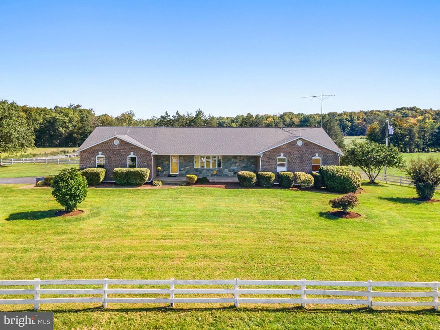 Welcome to this expansive brick rambler on 10 breathtaking acres, nestled in serene farmland—ideal for horses or anyone who loves wide-open spaces! This home boasts hardwood floors throughout and spacious rooms bathed in natural light. The massive kitchen features ample cabinetry, an island, a built-in desk, and double wall ovens, perfect for any home chef. Relax in the sun-drenched sunroom with panoramic views or cozy up by the gas fireplace in the living room. The home also offers wide hallways, walk-in closets, and an updated primary bath with a walk-in shower.

With over 4,476 sq. ft. of living space, including a finished basement, this home has plenty of room to spread out. Additional highlights include a 2-car attached garage, an incredible attached workshop/tool room, skylights, pocket doors, recessed lighting, and central vac. Enjoy your mornings on the covered front porch with stone detailing, complete with sidewalks and recent improvements throughout the home. Don’t miss this gem that combines luxury and practicality on a private, scenic lot!