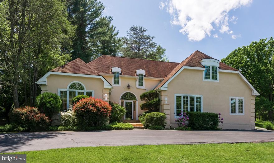 Welcome to 504 Chandler Lane, an exquisite 3-bedroom home with 1st floor Master in the heart of Villanova in Radnor Township and School District with Ithan Elementary. This elegant French Colonial home offers a harmonious blend of sophistication and comfort, set on a sprawling 1.21-acre lot. As you approach, be captivated by the home's wonderful curb appeal and lush green yard adorned with mature plantings. The recently remediated stucco and new paint, completed in 2024, comes with a 10 year warranty, ensuring peace of mind.
Step inside to experience a beautiful two story foyer with porcelain floors an introduction to the open and inviting layout. The formal living room is generously sized, with interesting ceiling heights and oversized windows with custom wooden shutters. It shares space with the formal dining room, which opens to a wraparound deck accessible from the dining room, kitchen, and three-season Sunroom, enhancing flow and functionality. The relaxing Sunroom provides complete views of nature, complemented by a decorative stained-glass window embedded in the wall. It was recovered from a church, and is backlit for added ambiance.
The heart of the home is the open double island kitchen with dining area that opens into the expansive cathedral ceiling Family room, which opens to the Sunroom. The Family room boasts walls of windows that flood the space with natural light. This kitchen is perfect for culinary endeavors, equipped with plentiful counter space, cabinetry, and a double oven. Recessed lighting enhances the natural illumination, while a mechanical skylight and awning offer additional light control.
The first-floor owner's suite features a walk-in closet and an updated bathroom with a glass-enclosed shower, built-in soaking tub, and dual vanities. Upstairs, discover two spacious bedrooms, a shared bathroom, and a versatile loft area ideal for work or leisure.
Convenience is key with a two-car garage leading into a multifunctional mudroom/laundry room. The home also includes a security system, air conditioning, a fireplace, and an expansive unfinished basement for storage. A Kohler generator ensures peace of mind during power outages. This Villanova gem invites you to experience comfort and elegance in a serene setting and is conveniently located minutes from the Blue Route 476, with easy access to downtown and the Philadelphia airport.