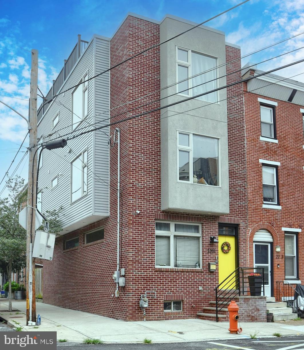 CHECK OUT THE VIDEO TOUR OF THIS PROPERTY AT https://youtu.be/V2NQyFzo4Qk. Welcome to 2201 E. Susquehanna Ave. This stunning, fully renovated classic Philadelphia rowhome is nestled in the vibrant Fishtown area. This stately, corner, 3-story brick gem offers a spacious layout with 3 bedrooms and 2.5 bathrooms across 2,300 sq ft. Laid out for both comfort and style, this is a perfect canvas for modern urban living. The living room has large windows and recessed lighting which highlight the classic, natural toned hardwood floors and an open-plan living area and dining area leading to the elegant kitchen. Here you will enjoy a generous number of rich toned cabinets contrasted by the bright white countertops, stainless steel appliances, and island with sink. Off of the kitchen, are sliding glass doors that lead to your own private backyard oasis complete with custom built seating and storage. Perfect for those summer nights with friends. The second floor features 2 spacious corner bedrooms, a full bathroom, and laundry area. The real treat is on the the third floor. Here you have a primary suite accessed via a barn door. The suite includes a spacious bedroom, full bathroom with walk-in shower, and double sink, and a room sized California Closet that has a huge window and space for a vanity. Climb the spiral staircase to the roof deck with epic, breathtaking views of the city and surrounding area. The high-ceilings in the finished basement create the perfect flex space, ideal for use as a home gym, entertainment area, playroom, family room, or office. The accent wall, recessed lighting, powder room and loads of additional storage in the basement highlight the value this space adds to this home. Central air conditioning, ceiling fans in the bedrooms, gas heating, and modern amenities ensure year-round comfort. Just steps from bustling Frankford Ave, this home places you in the heart of Fishtown’s thriving community. Walk to top-rated restaurants, art galleries, the city’s best thrift shops and enjoy the music scene at The Fillmore and Frankford Hall among others. Seamless commuting via convenience access to public transportation and an active Uber/Lyft area. Move-in ready, 2201 E Susquehanna awaits your personal signature. Schedule your private tour today—don’t miss the chance to own this exquisite Fishtown residence, where urban energy meets refined comfort.