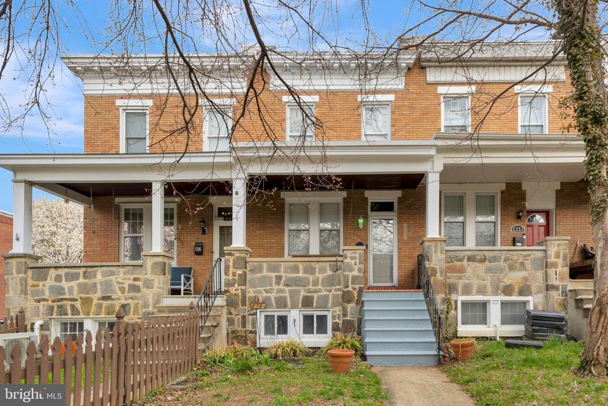 **  Seller asked for all offers to be submitted by Monday April 6 at 4pm **

Welcome to 1214 W 40th Street—where charm, space, and lifestyle come together in the heart of Hampden.

Tucked into a quiet, friendly neighborhood, this home offers the best of Baltimore living with incredible walkability. Just steps away, you can stroll to local grocery stores, coffee shops, restaurants, and boutiques along “The Avenue,” and enjoy everything that makes Hampden Village such a vibrant and sought-after community.

From spring through fall, the street is framed by a beautiful canopy of mature trees that arch overhead, creating a shaded, picturesque setting that adds to the charm and everyday enjoyment of the neighborhood.

Start your mornings on the welcoming front porch, coffee in hand, as neighbors pass by on the sidewalk—this is the kind of place where life feels connected and relaxed.

Inside, you’ll immediately notice something rare for the area—a wider layout and tall ceilings that create an open, airy feel throughout. The front living space showcases beautiful original hardwood floors with over 100 years of character, complete with detailed inlay borders that add timeless charm.

The entire home has been freshly painted, giving it a clean, bright feel and making it truly move-in ready for the next owner.

The heart of the home is the brand new kitchen, remodeled in 2025, thoughtfully designed with white cabinetry, quartz countertops, new flooring, and updated lighting—blending modern style with everyday functionality.

Just beyond, step into the enclosed rear porch with skylights, a perfect flex space for relaxing, working, or entertaining. From there, you’ll find your private backyard oasis, featuring a tall white vinyl privacy fence and your own dedicated parking pad—a true bonus in the city. There is also ample street parking, making it easy for guests to visit.

Upstairs, you’ll find three bedrooms ready for your personal touch and a beautifully remodeled full bathroom in the hallway.

The finished basement offers impressive ceiling height and versatile space, including a front workshop or storage area, a spacious recreation room, and a rear laundry room with washer and dryer plus additional storage.

Major updates include the main roof replaced in 2018 and regularly maintained, the front porch roof replaced in 2021, and the rear porch roof replaced with the addition of skylights.

This home offers not just a place to live, but a lifestyle. Walkable, welcoming, and full of character, it’s everything buyers love about Hampden.

This is the one you’ve been waiting for—welcome home.
