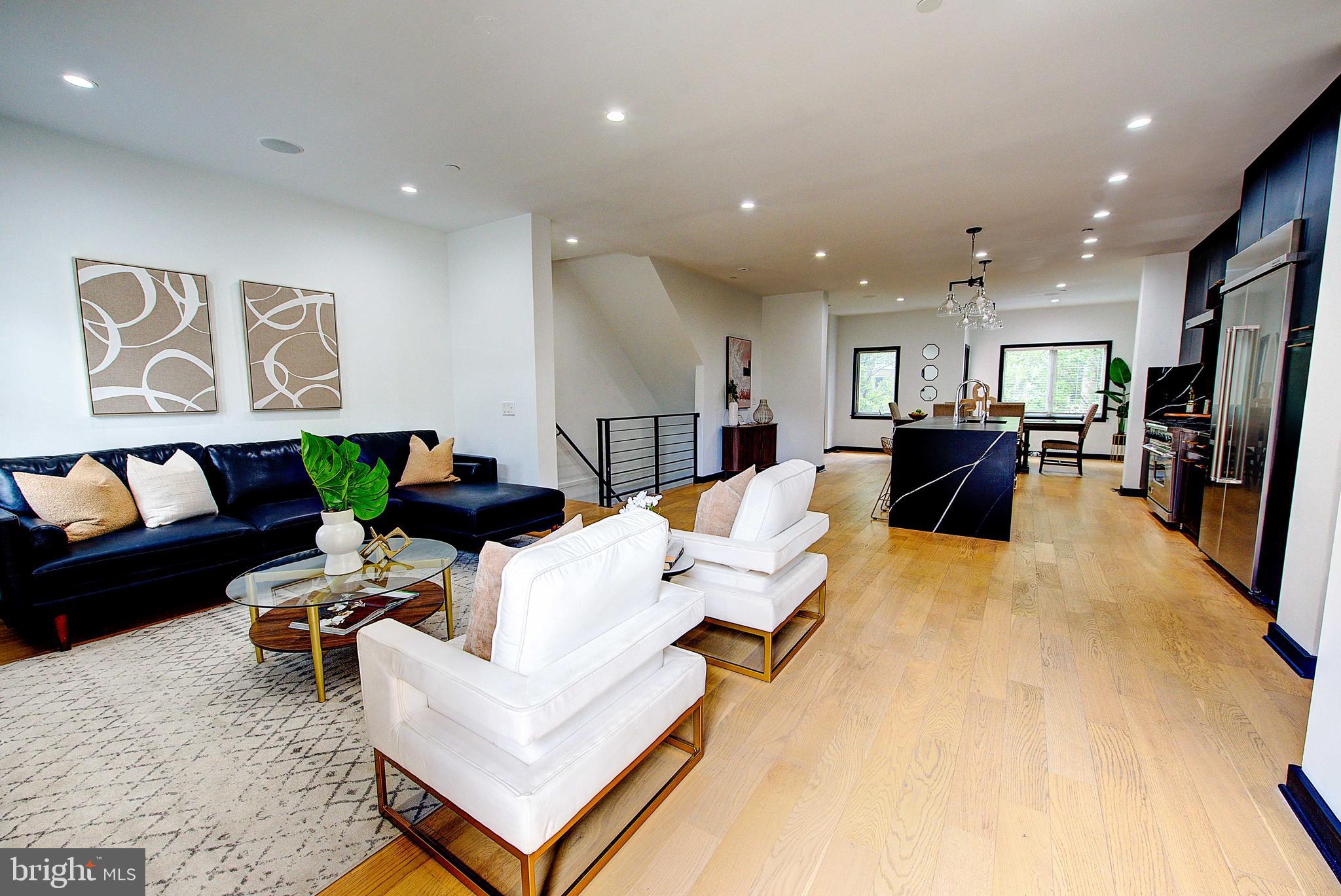 A Modern Masterpiece in the Heart of Graduate Hospital
1424 Kenilworth Street | Gated Community | 22’ Wide Townhome | 2-Car Garage
Step into the epitome of refined urban living with this architecturally striking, 22-foot-wide contemporary townhome nestled in an exclusive gated enclave in the sought-after Graduate Hospital neighborhood. From its dramatic black ceramic foyer to the breathtaking skyline views from the rooftop deck, this home is a rare blend of modern elegance and everyday luxury.
First Floor:
Enter through a bold, oversized doorway into a chic black-tiled foyer that sets the tone for the home’s elevated design. This level features a spacious guest suite with a full bath—ideal for in-laws, guests, or a private home office. Direct access to the two-car garage and a fully finished basement offers flexible space for a gym, media room, or wine cellar.
Second Floor – Grand Entertaining Level:
The main floor is an entertainer’s dream, boasting soaring ceilings, wide-open spaces, and floor-to-ceiling windows that flood the home with natural light. The gourmet chef’s kitchen is a showstopper—anchored by a dramatic black quartz waterfall island, custom ebony wood cabinetry, a walk-in pantry, and premium appliances including a Sub-Zero refrigerator, six-burner range with hood, pot filler, and dishwasher. Adjacent, the formal dining room and expansive living area with a walkout patio provide effortless flow for hosting. A discreet powder room adds convenience and charm.
Third Floor – Owner’s Sanctuary:
Retreat to the primary suite, a sumptuous sanctuary featuring large bedroom, a cozy sitting area with fireplace, custom-designed walk-in closet, and spa-inspired bath. Indulge in the soaking tub beneath sunlit windows, a glass-enclosed stall shower, and a double vanity adorned with modern ceramic tile. A second bedroom on this level serves perfectly as a nursery, dressing room, or private office.
Fourth Floor – Private Quarters + Skyline Views:
Two additional generously-sized bedrooms share a sleek hall bath and are complemented by a dedicated laundry room. These two bedrooms can be easily be converted back to one very large bedroom .
Step outside to your rooftop terrace, where panoramic views of the Center City skyline create an unforgettable backdrop for morning coffee or evening soirées under the stars.
Bonus Features:
• 3,884 sq ft of living space
• Designer finishes throughout
• Gated community privacy and security
• Two-car garage with interior access
• Rooftop deck with 360° views
This rare contemporary jewel offers sophisticated city living with the feel of a private estate—all within minutes of Rittenhouse Square, top-tier dining, theatres and world-class shopping.