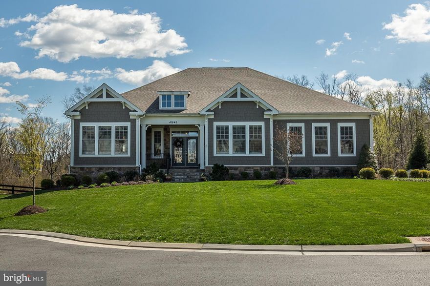 Imagine coming home to this amazing ranch style beauty with breathtaking views overlooking mature trees and gorgeous sunsets!  Easy main level living at its finest with phenomenal outdoor living spaces!  Enjoy the sights and sounds of nature along with views of the conservancy from the impressive outdoor living area.  Relax and unwind on your gorgeous custom deck with a stone front fireplace. Enjoy a cup of coffee to start your day or a glass of wine to unwind while you take in the beautiful views!  Stunning Arcadia built (extended) Brickland model with unique features and bright, open, spacious floor plan situated on a .34 acre lot backing to conservancy. Three car oversized garage with epoxy flooring and wide storage shelving.  Over 5,200 sf of finished living area and outdoor living spaces make this home ideal for personal and business entertaining.  MAIN LEVEL FEATURES-You will love creating spectacular meals in the chef's kitchen with stainless steel GE Monogram appliances with range hood, gas cooktop, and tons of counter space.  Custom 12 x 6 kitchen island with marble stone sink and breakfast room open to great room with double sided fireplace.  Butler's pantry with upgraded cabinets and generous custom walk in pantry with shelving and cabinets just off formal dining room.  Main level owner's suite leads to covered deck and has an en-suite spa like bath with sliding double barn door entry. Enjoy the deep soaking tub, deluxe shower, huge vanity and custom closet!  Two additional bedrooms on this level with private baths.  The center of the main level is graced by the iron balusters leading to the expansive club level! CLUB LEVEL FEATURES: The impressive lower club level has access to the stunning back yard through two separate walk out areas to a ginormous patio.  Host a private party for your friends or a dinner party for your business associates in style with your custom bar, recreation room and impressive outdoor space! There is plenty of room to watch a sporting event or movie with your guests or for a friendly game of pool!  The custom bar is second to none!  Additional bedroom suite with huge walk-in closet and deluxe full bath with spacious walk in shower.  Abundant amount of storage space can easily be modified for additional living area.  Workshop with shelving and concrete floor perfect for a hobby room.  OUTDOOR FEATURES- Great outdoor space includes 9-zone irrigation system for front and back yards, extensive professional landscaping, mature trees, and extra long driveway!  Outdoor living includes a 40' x 20' partially covered trex deck with fireplace and a massive stone flag patio with retaining wall where you can enjoy the great outdoors!  You will love it here!