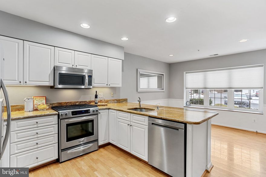 Welcome home to this freshly painted, bright & immaculate 2 bed/2 bath (step right up, literally) condo in the highly sought after community of Mays Chapel North! This beautiful first floor condo offers gleaming hardwood floors, updated bathrooms & a spacious, modern kitchen with granite counters, stainless steel appliances & plenty of space to enjoy meals. The lovely gas fireplace will keep the cozy living & dining spaces even warmer on those cold winter nights! Additional charming features include foyer style entrance, master bedroom walk-in closet, ample storage throughout, and sturdy window blinds!  You'll be thankful for the bonus exterior entrance, which is convenient for carrying in groceries and letting pets out for walks. Enjoy the exterior patio, great for  relaxing with coffee in the morning and entertaining in the evenings while watching the parade of strollers and dog walkers! You'll feel like a part of this warm and friendly community in no time! Conveniently located off I83 close to shopping, restaurants & Graul's gourmet market. Make your offer & start enjoying all the conveniences of condo living today!