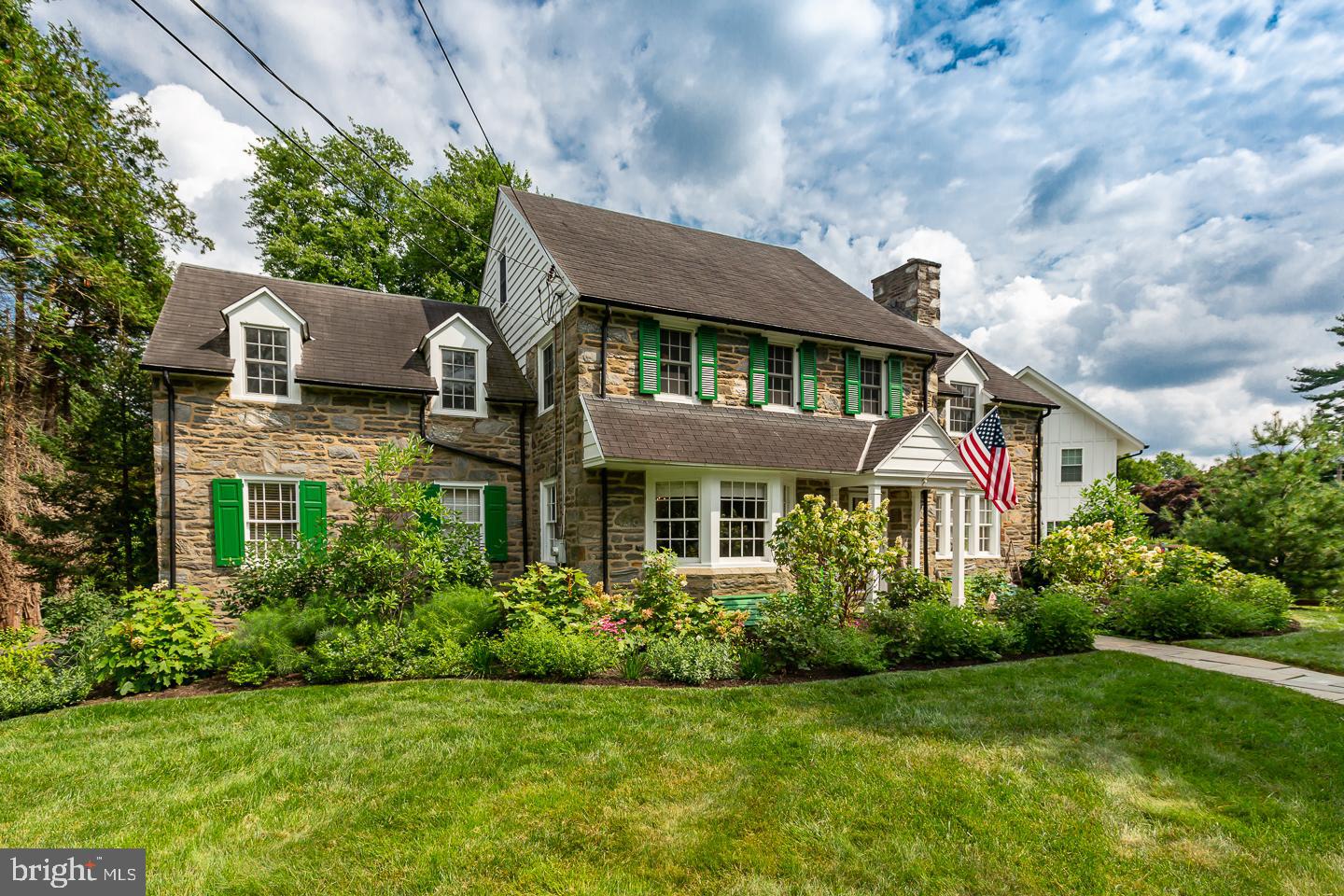 Situated in one of the most desirable neighborhoods on the Main Line, this stately stone colonial sits on a flat, professionally landscaped .45 acre property. This home offers an elegant and spacious floorplan that boasts high quality updates and charming architectural details such as deep windowsills, built-in shelves, hardwood floors and wainscotting along with graceful arched windows and doorways.
Enter through the center hall to a well-proportioned living room with recessed lighting, lots of windows and a wood burning fireplace. The living room flows outside to a covered patio - perfect for entertaining or as a quiet oasis for relaxing. Across the center hall, a sun filled dining room with bay windows, crown molding and wainscotting, flows to a generous sized chef’s kitchen with a subzero refrigerator, pantry closet and an island with seating. The kitchen extends to a family room with a gas fireplace, built in shelves and windows on all 3 exposures. The family room opens onto a mahogany deck overlooking the fenced in backyard, ideal for daily family living or al fresco dining and entertaining. An office and a half bath complete the 1st floor. The lower level contains a finished basement with plenty of room for gym equipment and game tables, in addition to large unfinished storage spaces and a laundry room with stairs up to the backyard.
The second floor includes four bedrooms and three full bathrooms. The spacious owner’s suite has an ensuite bathroom and double closets with built ins. The guest room with ensuite bath is private at the end of a hall; two additional bedrooms and a hall bath complete the second floor. The third floor has a bedroom with bathroom ensuite – ideal for guests or an au pair and a large attic with plenty of storage space.
Updates include installation of two A/C units and a boiler, a new hot water heater, new windows on the 2nd and 3rd floor, custom window treatments and blinds throughout, refinished hardwood flooring on the 1st and 2nd floor, 2.5 new bathrooms and professional landscaping designed bloom with the changing seasons.
Located in the award-winning Lower Merion School District and the highly sought high school choice catchment. This property offers the comforts of suburban living with outstanding walkability to downtown Narberth, R5 train SEPTA bus routes and numerous other conveniences.