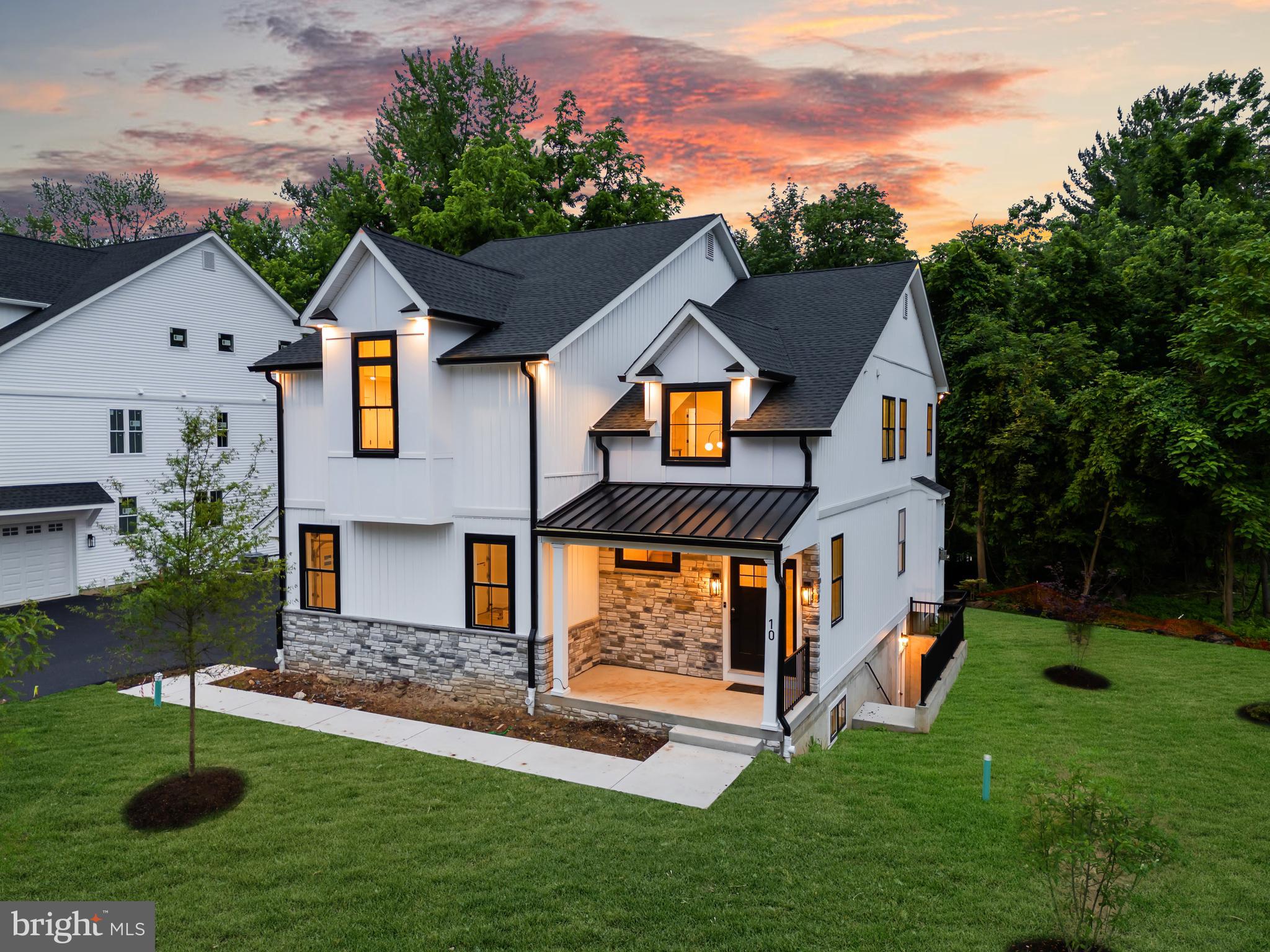Introducing 10 Churchville Ln, the second of ONLY three exclusive custom farmhouse style homes in the highly anticipated Churchville Pointe enclave. This stunning 4-bedroom, 3.5-bathroom farmhouse-style home blends timeless charm with modern luxury, offering an expansive open floor plan and impeccable craftsmanship throughout. Step inside the soaring two-story foyer, where wide-plank white oak flooring flows seamlessly throughout the home. The spacious living room, centered around a gas-burning fireplace, provides the perfect setting for both relaxation and entertaining. A dining area, conveniently situated between the living room and kitchen, features a built in butler's pantry, adding a touch of elegance to your gatherings. The heart of the home is the gourmet kitchen, a true showstopper with custom two-tone thin shaker cabinetry, gorgeous quartz countertops, an oversized island, and high-end Café stainless steel appliances and wine refrigerator. Adjacent to the kitchen, a custom-built mudroom ensures stylish and functional organization. Through the mudroom, you'll find access to both the spacious two-car garage and a massive walk-in pantry. A striking custom iron railing with oak box handrails leads to the second floor, where each generously sized bedroom is designed to accommodate a king-size furniture set. The primary suite serves as a luxurious retreat, complemented by a spa-like en-suite bath featuring stunning wall-to-wall large-format porcelain tile, a free-standing soaking tub, a double vanity, a private water closet, and an oversized glass shower stall. The convenience of an upstairs laundry room adds to the home’s thoughtful design. Enjoy seamless indoor-outdoor living with a large, elevated Trex deck, perfect for entertaining or quiet moments overlooking the serene surroundings. The daylight walk-up lower level is an entertainer’s dream, featuring high ceilings and complete with an additional full bathroom—ideal for a guest suite, home gym, or media room. Additional highlights include Andersen windows, a high-efficiency Carrier HVAC system, Bradford White tankless hot water system, and a spacious two-car garage. Nestled in a coveted location, 10 Churchville Ln offers a rare opportunity to own a one-of-a-kind custom home in a picturesque setting, conveniently close to major transportation routes and the charming hamlets of Richboro, Newtown, and New Hope. Experience the pinnacle of modern farmhouse living at Churchville Pointe—schedule your private tour today!