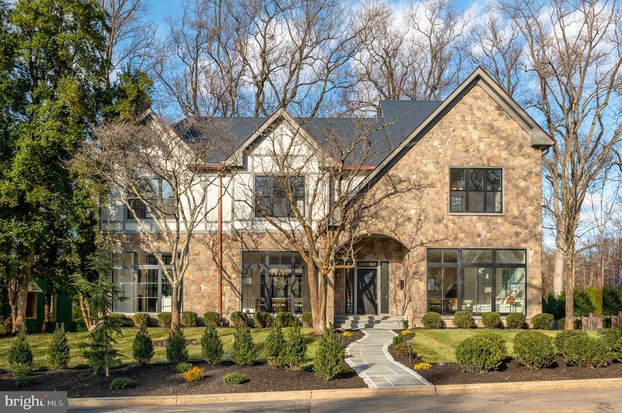 Transcendent and visionary reimagining of a classic Spring Valley home done in the modern Tudor style. Executed with the finest finishes by Dilan Homes, 5045 Overlook Road brings a new level of sophistication and luxury to one of Washington's most coveted neighborhoods. Illuminated on all sides by natural light, this home features a clean, warm and inviting aesthetic that is elevated by European white-oak floors, soaring 10+foot ceilings on the main levels and full length windows throughout. An open contemporary layout grounded by a designer gourmet kitchen with high end appliances and a massive quartz island, adjoining family room with eat-in area, butlers pantry, expansive combined formal living/dining area with wood burning fireplace and statement glass mullioned ensconced office combine to create a livable main floor that exudes style while creating spaces for both formal and informal entertaining. Upstairs the discerning buyer will find 4 gracious bedrooms including an owner's retreat with private deck, a beautifully appointed walk-in-closet and spa bathroom with an oversized ceramic soak tub and 10+ foot rainfall shower. The lower level of the home is comprised of a spacious recreation room, 5th bedroom, primary laundry facilities, mudroom, 2 car garage and gym with sliding glass doors that lead out to over 14,000 square feet of landscaped grounds. Across the rear patio grounds is a fully detached carriage house that provides an additional 2 garage spaces and a full independent one bedroom apartment. This home has too many features to list and must be seen to be appreciated. Truly unique and one of a kind, this statement home provides unparalleled aesthetics, design and livability in the heart of Northwest Washington DC.