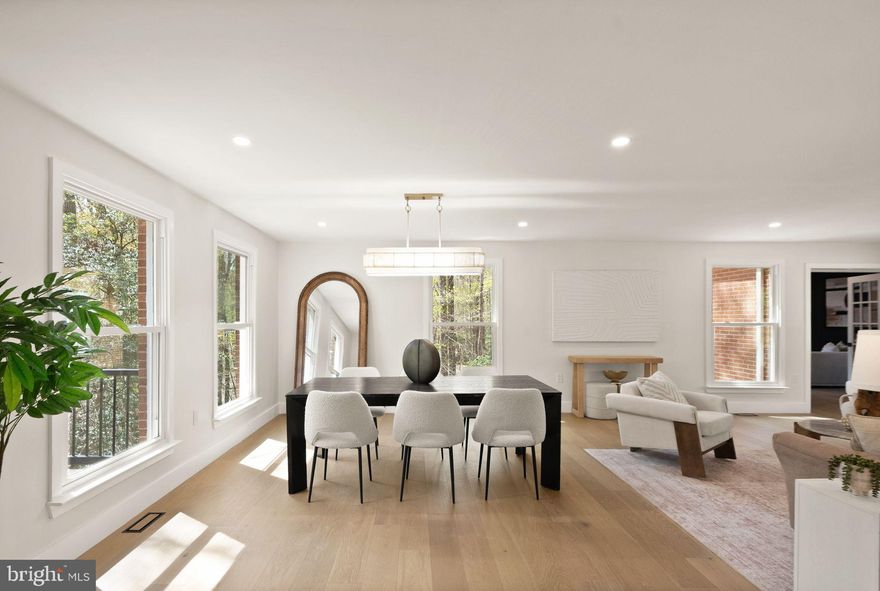 This classic Great Falls estate has been completely reimagined and renovated with top‑of‑the‑line finishes and carefully curated design that fuses modern elegance with everyday function. Set on a serene, wooded 5‑acre lot, the nearly 7,000 sq ft of living space is move‑in ready and offers something for everyone. The main level showcases a gourmet chef’s kitchen with a 12' attached pantry, designer induction dual oven, striking hood, two dishwashers and a Cafe Series refrigerator—ample room to cook and entertain. The kitchen opens to a beautifully designed wet bar with custom Cafe beverage drawers and to a dramatic brick‑front hearth with wood‑burning fireplace that frames views of the private backyard. Seamless indoor‑outdoor living is perfected by the new main‑level deck, while the open living and dining rooms balance everyday comfort with the grace to host the most lavish affairs. The main‑level Great Room is an inspiring retreat, finished with custom moldings and abundant windows that flood the space with natural light. This exceptional property blends refined finishes, smart layout and peaceful acreage to create a rare Great Falls opportunity.