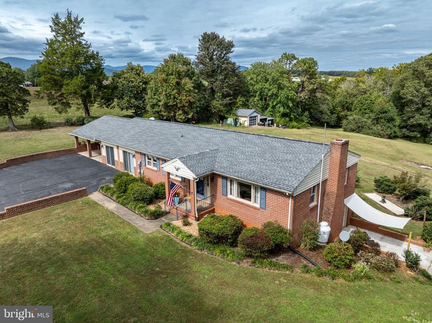 Welcome home to this well-maintained brick ranch that truly has it all!  Perfectly situated just minutes from Shenandoah National Park, Charlottesville and Culpeper, this property offers both convenience and natural beauty.  
Enjoy the year-round views of the Blue Ridge Mountains,  or take a refreshing dip in the pool during the summer months.  With no HOA and 2.36 acres, you'll have plenty of privacy and space to grow.  
Inside, you'll find comfortable living with room to entertain.  
The main floor boasts 3 bedrooms and 1.5 bathrooms, kitchen, dining room, and a large sunroom with a bar ready to host your next big party.
The finished basement offers a bonus room, kitchenette, closet space, bathroom, office/laundry room, brick fireplace and private entrance.  If you're looking for extra space for your growing family-this home has you covered.  
Outside you'll enjoy a spacious front and back yard complete with a cozy fire pit, fenced -in pool, carport, and garage/workshop.  
Recent upgrades include a brand-new roof with 30-year warranty shingles, a new distribution box, and new well pump.  
Come see for yourself all that this home has to offer.  With it's peaceful setting, convenience to amenities, versatile living spaces, and room to make it your own, it's the perfect place to put down roots and create lasting memories.