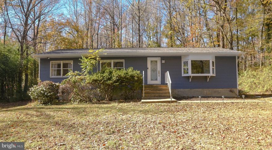 Back on the market! Sitting on just over an acre, this well maintained rambler offers both seclusion and convenience. Beautiful hardwood floors welcome you inside to the family room, which is open to the dining area and galley kitchen boasting tons of cabinet space. Enjoy your coffee and the nature views from the flex room off the dining area, then walk right out to your back yard that is not only perfect for entertaining, it's a level lot, allowing endless possibilities to make it the backyard oasis of your dreams. You'll find the primary bedroom on the main level with two additional bedrooms, along with the fourth bedroom and a full bathroom in the basement. The important upgrades have been in made, like a new roof, vinyl siding, seamless hidden hanger gutters and downspouts, so all you need to do is move in and make it your own. Additional items to note, septic tank and heat pump was replaced within the last seven years. Schedule your tour today!