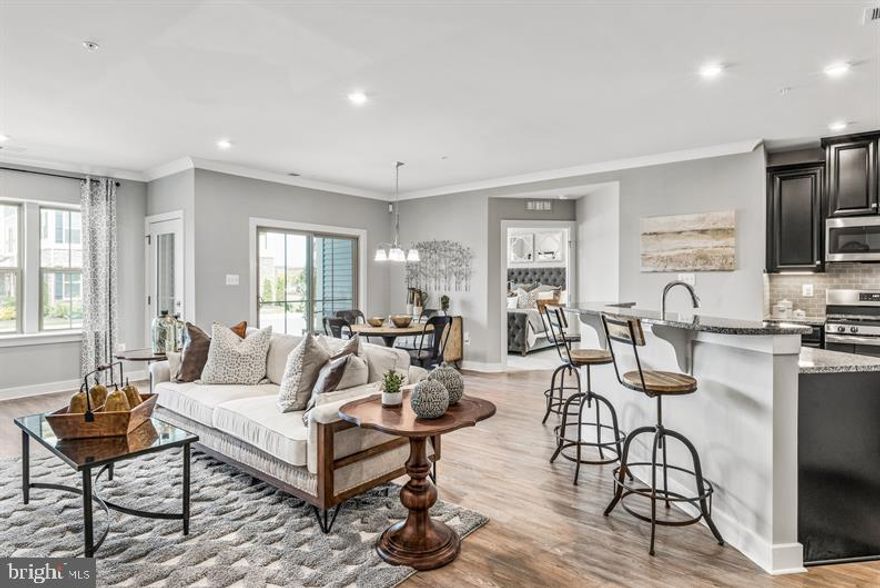 Immediate Delivery with VIP pricing!!!  $7,500 towards closing with NVR Mortgage, plus 1 year of Condo fees paid for VIP's.  Visit ryanhomes.com to become a VIP.  Welcome to your new home. The Chambord at The Woodlands Condos  is a spacious elevator condo with a 1-car garage.  As soon as you enter the foyer, you'll see how luxury and convenience can converge to create the home you need in the space you want.  A large coat closet and storage area give you plenty of space to stow your things.  As you walk in, the light and airy Great Room greets you with a bank of windows through the Sunroom, leading to a private balcony.  Open to the Great Room over a convenient breakfast bar, the Kitchen features plenty of counter and cabinet space and a large pantry. The Owner's Bedroom features two large closets (one of which is a walk-in!). The owner's bath has a double bowl vanity and offers either a tub or shower with seat. Through the foyer is another full bath, laundry area and second bedroom.  The Chambord is a flexible floorplan that you'll love to call home.  Escape the ordinary and discover The Woodlands, Urbana's only exclusive 55+ Active Adult Community. Enjoy low maintenance condo living.  Discover the ultimate active adult living experience with exclusive amenities designed to perfectly match your lifestyle including a pool, clubhouse, fitness center, game room, yoga studio, putting green, pickle ball, bocce ball, potting shed & garden, dog park, walking trails and more.  Beyond the immediate comfort of home, accessibility to the places that matter most is essential. Located in Southern Frederick County, walking distance to Urbana's vibrant Market District, minutes to historic Downtown Frederick, I-270 and the Montgomery County line.  The Woodlands of Urbana places you right in the middle of it all and connects you to everywhere you want to go.  Photo are representative.  Contact the sales team at 240.513.2414 to schedule your appointment today.  The model is open by appointment only during the VIP period.