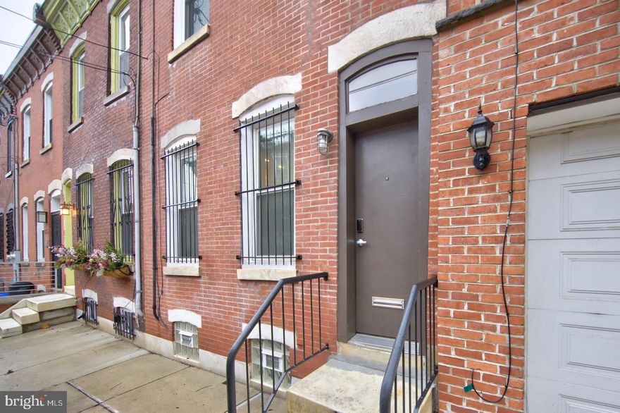 Chic, Hip Graduate Hospital pied a terre. Exposed brick, Chef's kitchen, large yard. 2nd floor is large open 1 bedroom, smaller 2nd bedroom with glass door, a large bath and a balcony overlooking the patio. Gorgeous wood floors throughout. Reasonable rental parking space available on block. Unfinished basement for storage. Close to Avenue of the Arts cultural attractions, Rittenhouse Square shops and restaurants, Broad Street Line.  Parking space available for rent on the block.