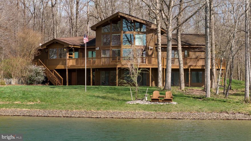 A rare and extraordinary opportunity at Lake Anna—this stunning waterfront Lindal Cedar home on the private side offers the perfect blend of lake living and mini farm potential, all set on 6.49 picturesque acres.
Approximately 800 feet of riprapped shoreline, plus a private pond, this one-of-a-kind property delivers unmatched waterfront living with breathtaking western sunset views. With over 4,400 square feet, 6 bedrooms, and 3.5 baths, there is room for everyone to relax and enjoy. Inside, the home showcases soaring vaulted wood ceilings, a dramatic wall of windows overlooking the lake, and a striking stone gas fireplace. The open-concept design seamlessly connects the family room, dining area, and kitchen—perfect for entertaining. The kitchen features granite countertops, a Jenn-Air double wall oven, and a Bosch dishwasher (just 2 years old). The main-level primary suite is complete with an atrium-style glass sitting area to soak in the views and a spacious walk-in California Closet system. Upstairs, a loft with a full bath offers flexible space for a bedroom, guest suite, or home office. The walkout lower level expands your living space with a large family room, four additional bedrooms, a full bath, and a utility/storage room—ideal for hosting guests or multi-generational living. Outdoor living is just as impressive, with a large upper-level deck and lower-level patio overlooking the water. Follow the path down to your covered boathouse with electric lifts, storage, and a sun deck. A waterfront gazebo and private boat ramp complete this exceptional lakefront lifestyle. Additional highlights include a whole-house speaker system, geothermal heating, fully paid-off solar panels (just 3 years old), reverse osmosis and water filtration systems, a 2-car attached garage, and a paved circular driveway. For those dreaming of a mini farm, the property is half fenced and ready to go, with multiple outbuildings, barns, run-in sheds, and a separate well that services the outbuildings and livestock.
Located in a small 7-lot subdivision with no current HOA dues (covenants and restrictions do apply), and a recently paved road with a future maintenance agreement anticipated. This is truly a once-in-a-lifetime Lake Anna retreat—offering space, privacy, waterfront beauty, and endless possibilities.