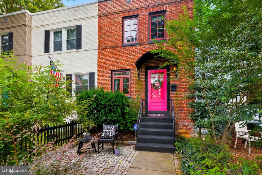 Perfectly positioned between Old Town and Del Ray and just minutes from the Metro, this stately and charming three-level brick-front row offers so much character in one of Alexandria’s most desirable neighborhoods. The stunning pink front door framed by bold black accents adds unforgettable curb appeal.  Interior elegant design details include luxurious wallpaper, sophisticated light fixtures, classic molding, and freshly painted walls throughout. Gleaming hardwood floors flow across the top two levels, creating a warm and inviting feel.    The kitchen has been totally remodeled with a farm-house  sink overlooking backyard, beautiful lit cabinetry, vintage lighting, butcher block countertops and a hidden dishwasher. And in the living room, enjoy a cozy gas fireplace equipped with a remote control.  The lower level adds more living/entertaining space with room to add a bathroom if so desired.  And outside, an oasis awaits—an expansive, beautifully landscaped, fenced-in backyard with a two-tiered deck, perfect for entertaining or relaxing in total privacy. Recent updates provide peace of mind: hot water heater (2021), sound-proofed windows, stair railing (2022), electrical panel (2022), and new gutters and downspouts (2024).  With plenty of street parking, unbeatable access to neighborhood favorites in Rosemont, Old Town, and Del Ray, plus easy Metro convenience and proximity to DC, this home is a perfect 10!
