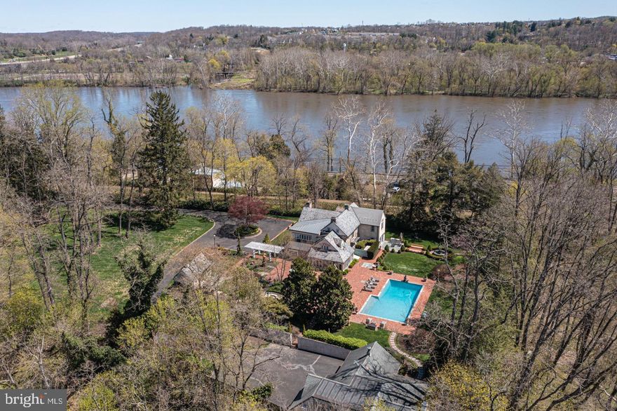 Back on the market with recent improvements! The privacy that abounds on this lovely, nearly 2 acre enclave gives the feel of being on an island yet only steps away from the vibrant downtown lifestyles of New Hope and Lambertville, tucked away and hidden from view along New Hope’s North Main Street. Enter the long, gated drive and take in the breathtaking beauty of the gorgeous specimen plantings and admire the storybook outbuildings that are cleverly positioned to provide convenient accessibility to one another while preserving the private, village feel. The main house, circa 1800’s, has all of the character and charm of a vintage home yet has been completely restored and expanded to offer the amenities for today’s lifestyle. This includes an extensive first floor Study and full bath that can serve as a main floor bedroom suite. The New Kitchen is bright and open to the Sunroom allowing for easy entertaining and the beauty of the outdoors to be a focal point of the interior. This home has been lovingly maintained and features New double-hung windows, New updated baths, many rooms with radiant heat floors, New 4 zone HVAC, speaker system and custom lighting throughout. Just across the brick walkway from the crystal, saltwater pool is the stunning Pool house with expansive recreation space including a hidden yoga/fitness studio with its own baths. Highlighting wonderful versatility, this space is graced with a soaring ceiling, wood floors, wood-burning fireplace and double garage. This special property also has a detached 200 s.f. cottage perfect for guests or days that you do not need to commute to a workplace. The professionally designed outdoor spaces bring the enclave to life with winding walkways that connect all of the buildings, whimsical fountains, wonderful entertainment areas including dining terraces and a dock with direct canal access. No expense has been spared in the thoughtfulness that the property offers. Additional amenities include a 12 zone irrigation system, whole property 60k generator, extensive exterior lighting for evening entertaining, deer fencing and so much more to experience. If you are looking for a quiet retreat near the towpath, shopping and entertainment in beautiful Bucks County than look no further. Truly a magical experience!