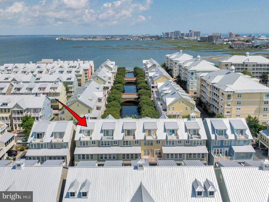 Welcome to 29 Sunset Island Drive—where every day feels like a coastal escape.

Tucked inside the gates of Sunset Island in Ocean City, this waterfront townhome invites you to slow down, breathe in the salt air, and settle into the rhythm of bayfront living. Mornings begin with coffee on a private balcony as the sun rises over the canal, and evenings wind down with glowing sunsets reflected on the water just steps away.

Inside, the home unfolds across four spacious levels, each thoughtfully designed for gathering, relaxing, and making memories. Built with the largest floor plan by NV Homes, there’s room for everyone—whether you're hosting a summer getaway or enjoying a quiet weekend retreat.

The main living level is where life naturally comes together. Conversations flow easily between the open kitchen, dining space, and multiple living areas, while a cozy game nook invites laughter after long beach days. It’s the kind of space where stories are shared, meals linger, and time seems to stretch just a little longer.

Upstairs, the primary suite becomes your personal sanctuary—quiet, comfortable, and removed from it all. Additional guest rooms offer welcoming spaces for family and friends, while the top-floor loft feels like a hidden retreat of its own, perfect for late-night chats, visiting guests, or simply a peaceful moment alone.

Step outside onto one of the home’s many balconies and you’ll feel it instantly—that unmistakable coastal calm. Boats drift by, breezes roll in off the bay, and the pace of everyday life fades into the background.

Beyond your front door, Sunset Island offers a lifestyle that’s just as inviting. Private beaches, pools, walking paths, and a vibrant sense of community make it easy to fill your days—or do nothing at all.

This isn’t just a home—it’s where summer lingers a little longer, and every visit feels like a getaway.