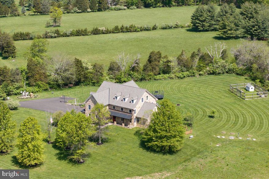 .Privately set on 33.8 acres of open fields and tree-lined boundaries, this custom 6,200+ square foot stone residence—constructed entirely in stone—offers a rare balance of privacy, scale, and accessibility, just over an hour from New York City.

Designed for both everyday living and extended stays, the home features a flexible, gracious layout well-suited for multi-generational living, guest accommodations, or a refined weekend retreat. Radiant heated floors, Brazilian hardwood flooring, and generous room sizes reflect quality craftsmanship throughout, while the home is comfortably livable as-is with the opportunity to tailor interiors over time to suit a more personalized aesthetic.

Positioned to one side of the property, the residence allows the surrounding acreage to truly shine—offering exceptional flexibility for a pool, equestrian pursuits, gardens, or the potential for a guest residence, subject to township approvals. The property directly borders High Rocks State Park, enhancing both privacy and the natural beauty of the setting.

Ideally located near Doylestown and New Hope, with easy access to Philadelphia, Princeton, and New York City, this offering presents a rare opportunity to secure meaningful acreage, privacy, and flexibility—without sacrificing connection to the towns, amenities, and lifestyle that define Bucks County living.