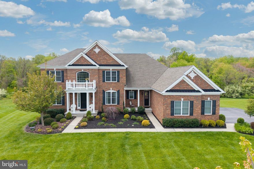 Located within the prestigious Enclave at Ridley Creek, this exquisite Colonial residence, built in 2018, epitomizes luxury living at its finest. Spanning an impressive 5,156 square feet, this like-new construction offers all the benefits of modern design without the wait, set on a premium, over 1-acre lot that backs to a private wooded area—creating a serene backdrop and the feel of an even larger property.

As you approach the home, the stately brick façade immediately sets the tone for the elegance found within. Step inside to discover soaring ceilings ranging from 9 to 10 feet, including a dramatic sunken living room that enhances the home’s open and airy feel. The thoughtfully designed open-concept layout seamlessly blends everyday comfort with refined entertaining spaces.

The main living area features a warm and inviting fireplace, while the gourmet kitchen is truly a host’s dream, complete with high-end appliances and an impressive setup that effectively includes three ovens—ideal for large gatherings and culinary enthusiasts alike.

Upstairs, you’ll find four spacious bedrooms, each with its own private en-suite bathroom. Two of the three guest bedrooms also feature walk-in closets, offering exceptional storage and comfort. The luxurious primary suite serves as a private retreat with a spa-like en-suite bath featuring dual vanities, a soaking tub, and a glass-enclosed shower.

Convenience continues with a main-floor laundry room, while the lower level walkout basement expands the living space significantly. Complete with a full bathroom (the fifth), this flexible area can serve as a bonus bedroom, in-law suite, or additional recreational space.

Outdoor living is just as impressive, with a generously sized backyard framed by mature trees that provide privacy and a tranquil natural setting. A three-car rear-entry garage completes this exceptional home.

With its combination of upscale finishes, functional design, and premier location within the Enclave at Ridley Creek, this residence offers a rare opportunity for luxury living in a move-in-ready home. Schedule your private showings before it’s gone!