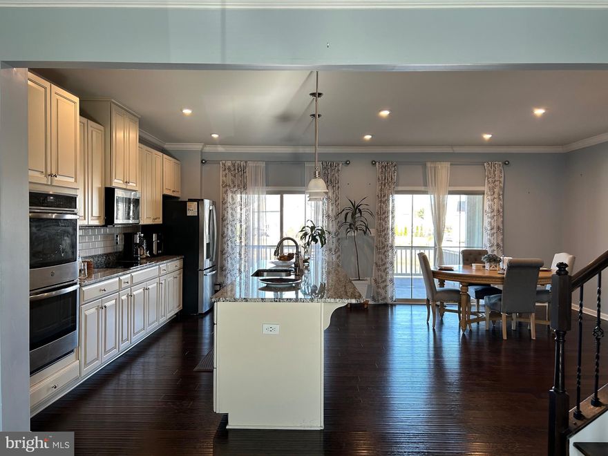 Available by May 1st.  A Rare Find! Welcome to this stunning, three-level townhome offering 3,120 sq. ft. of elegant living space, perfectly situated on a prime lot with breathtaking pond views. With only three townhomes on this exclusive side of the street, this is the largest model in the community, providing a rare opportunity for refined living in a highly sought-after location. From the moment you arrive, you'll appreciate the charm of the double-tiered deck, where you can unwind while watching ducks and geese glide across the tranquil pond. The backyard is a peaceful retreat—perfect for enjoying your morning coffee or evening sunsets. Step inside to discover a home designed for both comfort and sophistication. The lower level features a spacious guest suite with a full bathroom—ideal for visitors or multi-generational living. A mudroom with ample storage leads to the garage, ensuring easy maintenance and a polished look. The main level is a showcase of bright, open-concept living, boasting an oversized quartz island, upgraded backsplash, and gleaming hardwood floors in the gourmet kitchen. The seamless flow from the kitchen to the covered deck makes entertaining effortless while offering unparalleled water views. Upstairs, the expansive Master Bedroom is a luxurious retreat, complete with a HUGE walk-in closet, and stunning pond views. Two additional bedrooms, a convenient upstairs laundry room, and a hallway bath with dual sinks complete the upper level. Beyond the home, enjoy the vibrant community lifestyle, featuring picnic pavilions, a private Splash Park, multiple playgrounds, and recreational fields. Conveniently located just minutes from trendy dining, shopping centers, and historic Old Town Manassas, this home also offers easy access to scenic trails, the VRE, and major commuting routes. Don't miss this rare opportunity to live in a luxurious townhome in an unbeatable location—schedule your private showing today!