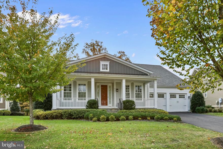 Welcome to 41221 Blue Oat Ct, a beautifully maintained home offering over 5,600 square feet of finished living space in the sought-after Greens South at Willowsford community. Every detail has been thoughtfully curated, blending everyday comfort with timeless design and a natural flow that makes the home feel both elegant and inviting.

Wide-plank hardwood floors and porcelain tile extend across the main level, creating a sense of warmth and connection from room to room. The entry unfolds into bright, open living and dining spaces filled with natural light, setting the tone for the home’s welcoming atmosphere. At the heart of it all, the kitchen impresses with quartz countertops, upgraded cabinetry, stainless-steel appliances, a convection oven/microwave, and a large pantry. The expansive island invites gathering, cooking, and conversation– a true centerpiece for daily living. 

Just beyond the main living area, the primary bedroom provides a peaceful retreat tucked privately at the back of the home. Gentle, natural light fills the room, and the adjoining spa-like bath showcases dual vanities and an extraordinary custom shower/bath designed for relaxation. An additional bedroom on this level includes its own en suite bath—an ideal setup for guests or multi-generational living, offering comfort and privacy on the main floor.

The finished lower level opens to a spacious recreation area that balances comfort and versatility. Soft, neutral carpeting adds warmth underfoot, creating an inviting setting for movie nights or casual gatherings. Two additional bedrooms and a full bath are well positioned for privacy, while two bonus rooms provide endless flexibility—perfect for a home gym,studio or media room. A generous unfinished section offers ample storage and organization space.

Step outside to a large screened-in porch that feels like a seamless extension of the home. It’s an ideal place to enjoy morning coffee, unwind in the evening, or entertain friends in comfort. Designed for year-round enjoyment, the porch can easily be enclosed with glass, and the backyard beyond offers plenty of room to relax or play. 

Recent upgrades include a new roof, new 50-gallon water heater, and a whole house water system with softener, charcoal filter, salt tank and reverse osmosis.  Even the garage makes an impression with its durable epoxy floor and organized finish.

Life in Willowsford is as inspiring as the home itself. This award-winning community offers a setting that feels both connected and serene, where tree-lined streets, scenic trails, and open green spaces create a true sense of place. Residents enjoy resort-style amenities including a pool, clubhouse with fitness center and lounge, tennis and basketball courts, dog parks, playgrounds, and more than 26 miles of walking trails that wind through meadows and woodlands. On-site retail, farm stands, and a community market make everyday errands simple, while neighborhood events bring friends and neighbors together throughout the year.

From this peaceful corner of Aldie, you’re just minutes from Route 15, Route 50, and the Dulles Greenway, making commutes to Northern Virginia, Washington D.C., and beyond remarkably convenient. Dulles International Airport is less than 30 minutes away, and weekends can be spent exploring Loudoun County’s many wineries, parks, and historic small towns.

41221 Blue Oat Ct is more than a home—it’s a lifestyle defined by comfort, connection, and quiet sophistication in one of Loudoun County’s most sought-after communities.