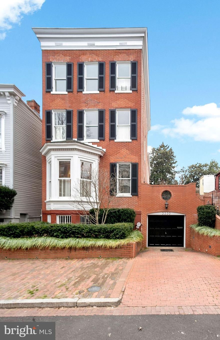 Simply magnificent, detached red brick Federal on one of Georgetown’s most authentic and historic blocks. Once home to Robert Kennedy, this grand house has wonderful views of Cox’s Row across the street and is the same block JFK left for the White House. The house has all the attributes one would expect from an important detached home; large windows for great light, ample gas fireplaces throughout, and large scale spaces with high ceilings and original details. The entry level enjoys light from four exposures and has the coveted floor plan of an eat-in kitchen, separate dining room, spacious living room and library all on the same  level. There are six bedrooms and four full baths with two half baths. The spaces in the house are both delightful and flexible, with extra bedrooms transitioning into excellent home offices, fitness rooms, or live-in spaces for help. There are terrific gardens on the side and the rear and a playhouse. There is two-car parking, including a one-car garage with a Tesla charger.