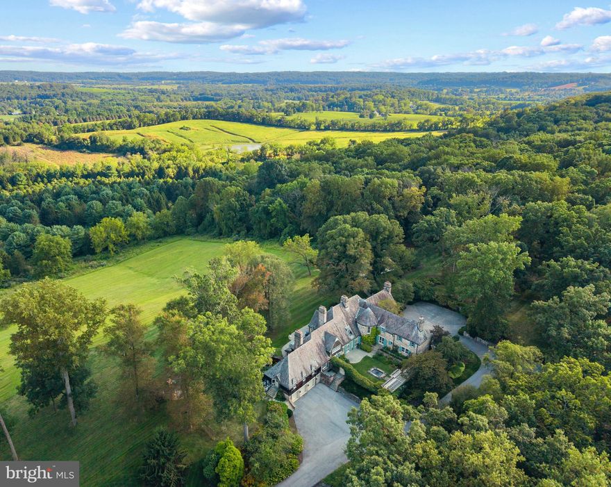 Live authentically. Sunny Hill Farm circa 1937. Brilliantly designed by William McMillan, storied architect. McMillan was also commissioned locally to design Alfred Vanderbilt's residence at Sagamore. McMillan married Grace G. Roosevelt, granddaughter of Theodore Roosevelt. They lived their days out at Sunny Hill. This is the second time it has been offered. A significant estate perched on 261 glorious acres with spectacular panoramic views of Worthington Valley. Masterful architecture. This English Country estate was sited in a way that dances with the sun. Your sense of arrival is punctuated by a very purposeful Moon Gate. I can only imagine an architect who is just as avid of a yachtsman would incorporate such a feature to connect with a framed view of the cosmos. Remarkable. Poetic interior and exterior courtyards grace every space. Soothing fountains are placed just so. Artistically framed views abound. Dazzling use of expansion and contraction. Sunny Hill will have a profound effect on you. A place to be cherished for generations. A cultivated trail network exists... adventure through vast woodlands, streams, orchards, and rolling farmland. You will experience microclimates from one end of the property to the other. Teeming with wildlife. Stroll seamlessly into the great outdoors and never miss a sunrise or sunset from one of your many terraces. Exquisite pool and hot tub. Ample space to curate pasture and equestrian facilities if desired. Greenhouse. Amish built five bay barn. Additional potential densities. Cultivate your existence. The art of uniting human and home.