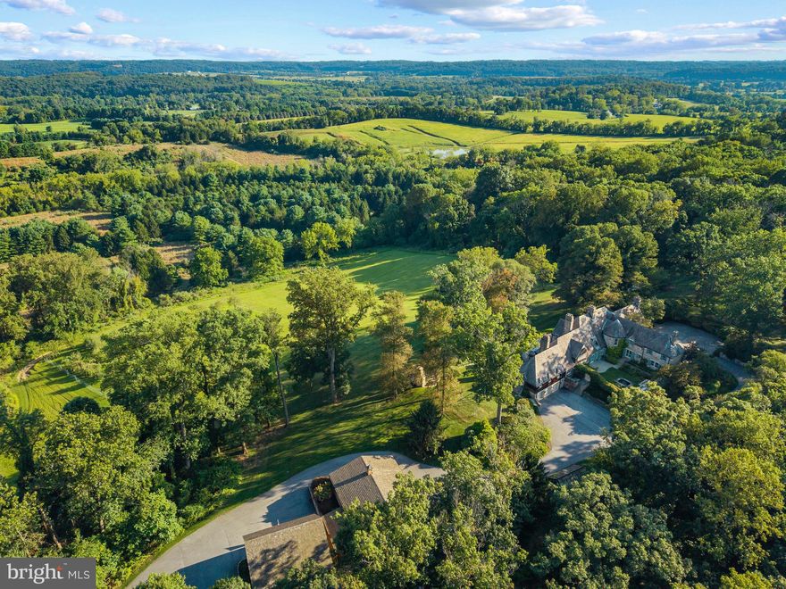 Live authentically. Sunny Hill Farm circa 1937. Brilliantly designed by William McMillan, storied architect. McMillan was also commissioned locally to design Alfred Vanderbilt's residence at Sagamore. McMillan married Grace G. Roosevelt, granddaughter of Theodore Roosevelt. They lived their days out at Sunny Hill. This is the second time it has been offered. A significant estate perched on 261 glorious acres with spectacular panoramic views of Worthington Valley. Masterful architecture. This English Country estate was sited in a way that dances with the sun. Your sense of arrival is punctuated by a very purposeful Moon Gate. I can only imagine an architect who is just as avid of a yachtsman would incorporate such a feature to connect with a framed view of the cosmos. Remarkable. Poetic interior and exterior courtyards grace every space. Soothing fountains are placed just so. Artistically framed views abound. Dazzling use of expansion and contraction. Sunny Hill will have a profound effect on you. A place to be cherished for generations. A cultivated trail network exists... adventure through vast woodlands, streams, orchards, and rolling farmland. You will experience microclimates from one end of the property to the other. Teeming with wildlife. Stroll seamlessly into the great outdoors and never miss a sunrise or sunset from one of your many terraces. Exquisite pool and hot tub. Ample space to curate pasture and equestrian facilities if desired. Greenhouse. Amish built five bay barn. Additional potential densities. Cultivate your existence. The art of uniting human and home.