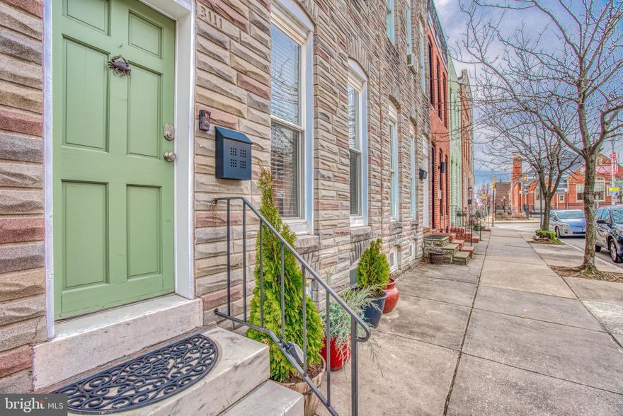 As you enter the house you are welcomed into a generous living room with a grand staircase gracing the rear of the room.  The wood  floors, tall ceilings, exposed brick hint at the features the home offers throughout.   The dining room with built in corner bench creates cozy casual environment for dining.  The kitchen has granite counters, double bowl sink with high arching single faucet, Stainless appliances, kitchen island with overhang and stylish ceiling fan.  Lots of light cascades through the windows and double doors that lead to a parking pad/court yard.   Currently, outside offers 2 large doors that enclose the rear yard creating a wonderful courtyard area.  Without the doors, you can use rear yard as a parking pad.  Upstairs you will find a grand master bedroom with 3 large windows,  2 closets, tall ceilings and a fan.   There is a bonus walk-in closet in the hallway, a spa like bathroom with separate tub and shower, and a rear bedroom with a door leading to a roof deck with stellar views.  The home also offers a powder room on the main level.  The full unfinished basement is currently set up as a fitness area and a storage area.