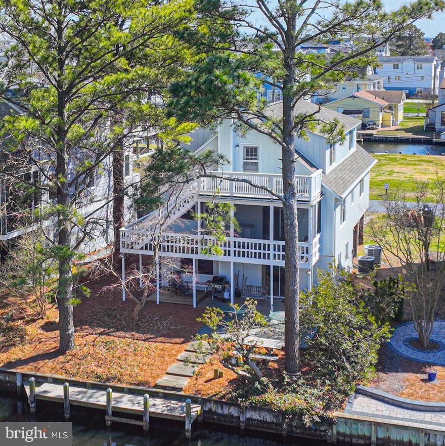 Waterfront & Walk to the Beach - Welcome to your ideal 4-bedroom, 3-bath coastal retreat in the heart of South Bethany. Primarily used as a rental, this home offers 3 levels of living, 3 levels of decks, a garage, and a private dock - perfect for beach and boating enthusiasts. The ground level features a one-car garage with ample storage, an outside shower, and a back deck leading to your private dock. Inside, a functional living area, laundry, and utility closet make it easy to keep beach gear organized. The main living level is designed for comfort and entertaining, with a great room, kitchen, and dining area that flows to a screened porch and open decking overlooking the waterways. This level also includes the primary suite with a tile shower, a guest bedroom, and a full bath. Upstairs to the 3rd level, a private retreat includes 2 additional bedrooms, a full bath, and an entertainment area with a wet bar, microwave, and refrigerator, plus dining area that steps out onto the top-level deck to enjoy waterfront views or watch the boats return with the catch of the day. Sold fully furnished with rentals in place. Summer rentals must be honored, with showings available between rental periods. Ideal for the beachgoer or boater.