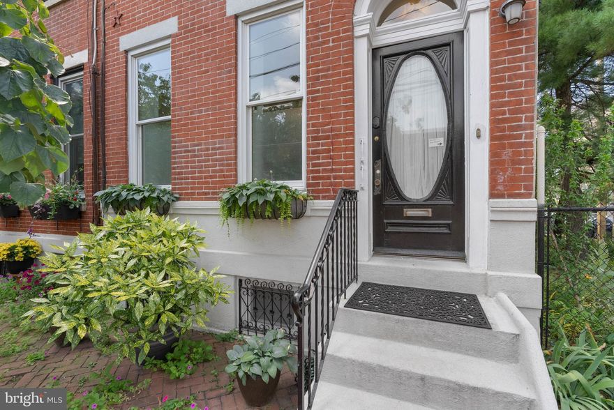 1942-44 Hamilton St offers the best of city living with a fantastic location in Philly's Art Museum neighborhood, plus suburban-like 2-car parking and outdoor spaces. This rare corner property features two separate parcels, 1942 Hamilton is an updated 4-bed, 1.5-bath, 3-story home and 1944 Hamilton is the adjoining lot currently used as an idyllic butterfly garden and parking or possibly build on the lot. A tree-lined block leads to picture-perfect curb appeal, showcasing a classic red brick facade enlivened by lush shrubbery. Inside, a foyer with a leaded glass door leads to the living room, where tall windows pour in natural light while hardwood floors and a marble mantel add character. Past the powder room, the open dining room and kitchen are sure to be the heart of the home, boasting sleek wood and glass cabinetry, high-end stainless steel appliances quartz counters, a tile backsplash, and lots of bright windows. Out back, the private patio is perfect for barbecues, gardening, and al fresco meals. Up on the second level, the large, bright primary bedroom at the front has hardwood floors and a dressing area with custom closets. A full bathroom and another sunlit bedroom are off the stairs. Two more bedrooms sit on the third level. Completing the home is an expansive dry basement with laundry and ample storage space. Utilities include central a/c, gas hot water, and gas heat. In addition to everything inside, 1942-44 Hamilton St's location earns a Walk Score of 96! From top restaurants and local shops to museums, parks, and trails, there's tons to explore just steps away. Target, Whole Foods, and Wine & Spirits are close, plus there's easy access to I-76 and I-676. Schedule your tour today!