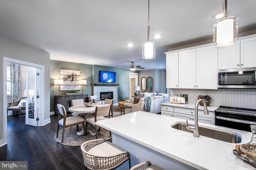 Come home to this beautiful 3-bedroom, 1-level condo at Clarksburg’s newest 55+ community, Gatherings at Cabin Branch! Move-in ready this summer! You can look forward to over 2,000 sq. ft., including a chef-inspired kitchen, an expansive living room with a 50” fireplace, and a dedicated dining area. Enjoy 2 sizeable secondary bedrooms with walk-in closets and a shared bathroom – perfect for guests! The luxurious primary suite offers a large walk-in closet and an en-suite bathroom with dual vanities, a linen closet, and an oversized shower with a seat. Included features: Elevator Access, 1-car garage, designer flooring in select rooms, Whirlpool stainless steel appliances, Harbor colored 42’ cabinets in the kitchen, and more. This home is rated Energy Series PLUS, meaning you receive enhanced construction features that deliver a tighter, more efficient home. In addition to being ENERGY STAR certified and Indoor airPLUS qualified, this home has higher performing low-e windows, HVAC equipment and ductwork in conditioned space, and more – saving you tons of money each month on utilities! *Pricing, features and, availability subject to change without notice. MHBR No. 93  2023 Beazer Homes.