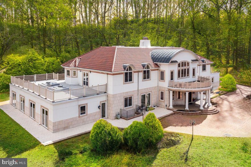 Welcome to 635 S. Ithan Avenue, an exceptional residence set on 1.47 acres in the highly sought-after Radnor Township school district. As you enter the property through the gated brick paver driveway, you are hit by the grandeur of this custom-built home. An extraordinary amount of thought and detail went into into designing this extremely well-maintained home and it truly shows. Beginning with the hand-carved, teak double doors that open to Calcutta marble floors, a double staircase, and 30-foot ceilings, this home is sure to impress with globally sourced materials and endless amenities. Beyond the double staircase is a large great room with a double-sided fireplace, three grand chandeliers, a built-in wet bar, and a wraparound hallway overlooking the room. The wall of windows in the connecting dining room allows an abundance of light and a beautiful view of the property beyond. To one side of the great room lies the kitchen, a spacious family room with a fireplace and bonus room that can be used for many things such as storing toys or as a small study room, a powder room, and access to the 3-car garage with a built-in car vacuum, wash station, and electric charger. The kitchen, designed by the owner and former restauranteur, is a true gourmet kitchen in every sense of the word beginning with the double islands and 2 countersinks. Appliances include a GE stove with 6 gas burners, a 2-burner griddle, a pot filler faucet and a high-powered, professional hood, a double door Sub-Zero Refrigerator, a combination wall oven/microwave, and a KitchenAid dishwasher. The floors and countertops are both granite stone and there is an abundance of cabinetry including a floor to ceiling wall pantry, storage, and coffee station/third dishwashing station. On the other side of the great room is a private 2-room office with built-in bookshelves, a full bathroom, and a separate entrance as well as an en-suite guest room, and a sitting room that leads to a stunning 32,000-gallon heated indoor pool and hot tub. The wall of doors in the pool area can be opened for an outdoor feel and the skylights above give it a sunlit ambience. Upstairs you will find one side dedicated to the primary suite and the other side consisting of 3 secondary bedrooms, each of which have double closets and en-suite bathrooms, and a laundry room. When entering the primary suite, you are greeted with a sitting area whichleads to the main part of the bedroom. In this oversizedprimary suite you will find a gas fireplace, 2 closets with custom built-ins, and a large en-suite bathroom. The primary bath boasts and oversized shower, soaking tub, sauna, steam shower, and more. Below the main level you will find a fully finished basement that is tailor-made for spending time with your family or hosting a large group. This space includes an oversized multi-functional room, an 18-seat movie theater, a guest bedroom with en-suite bath, and a separate, smaller gathering room. This home also has 7-zoned radiant heat throughout all 3 levels, 6-zoned A/C system , 3 hot water tanks, 2 generators… and the list goes on!